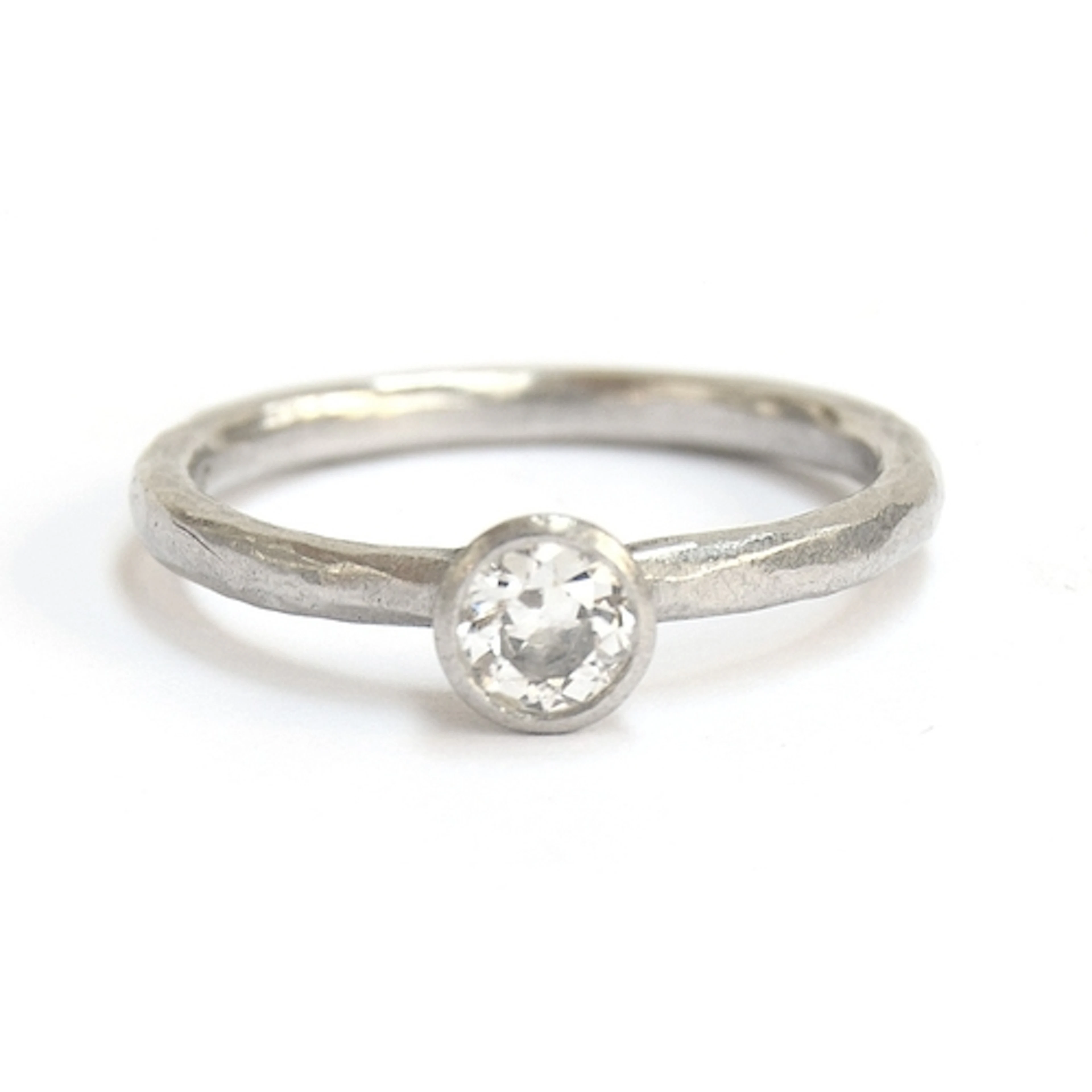 A Malcolm Betts platinum and diamond solitaire ring with ham...