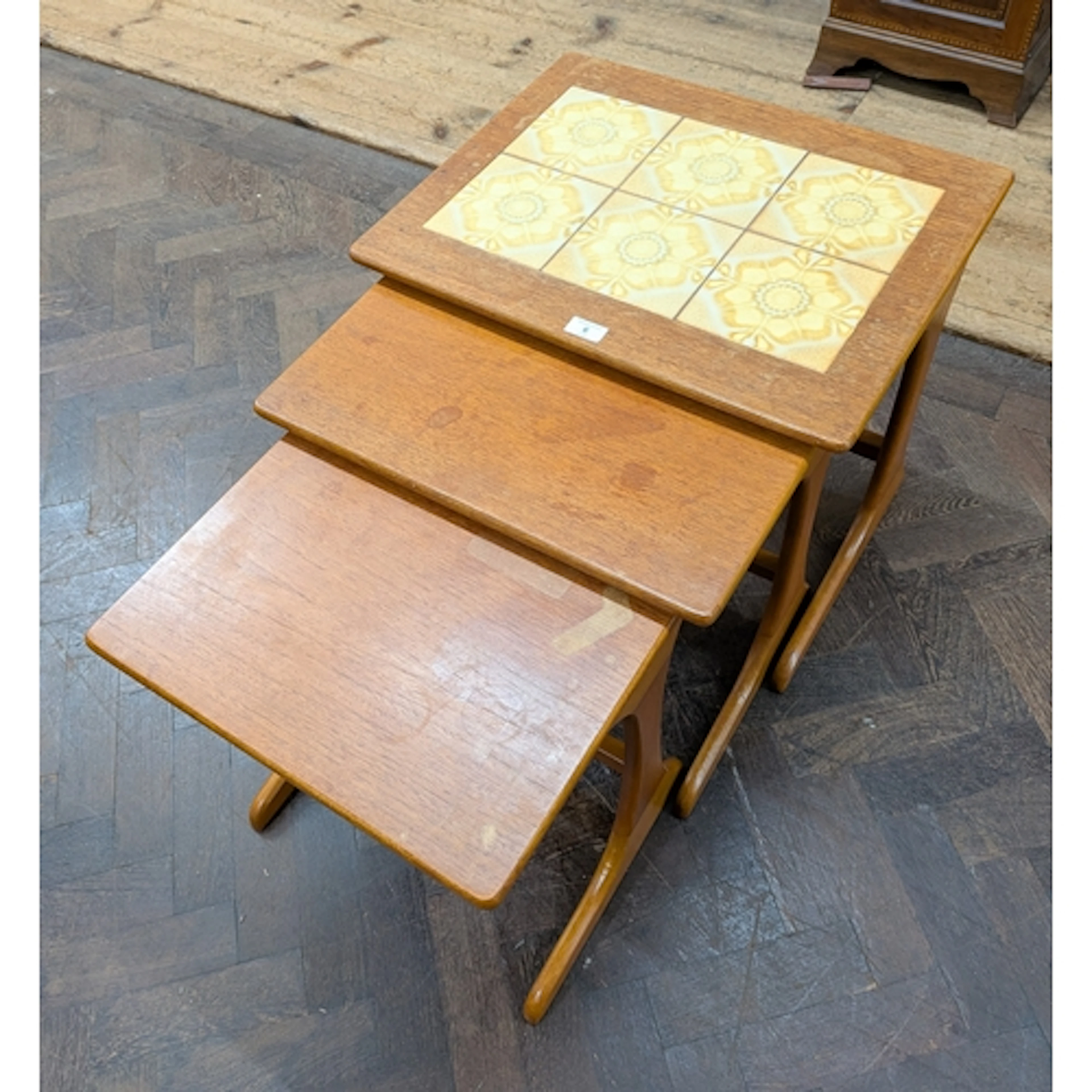 Nest of three retro teak tiled top coffee tables
