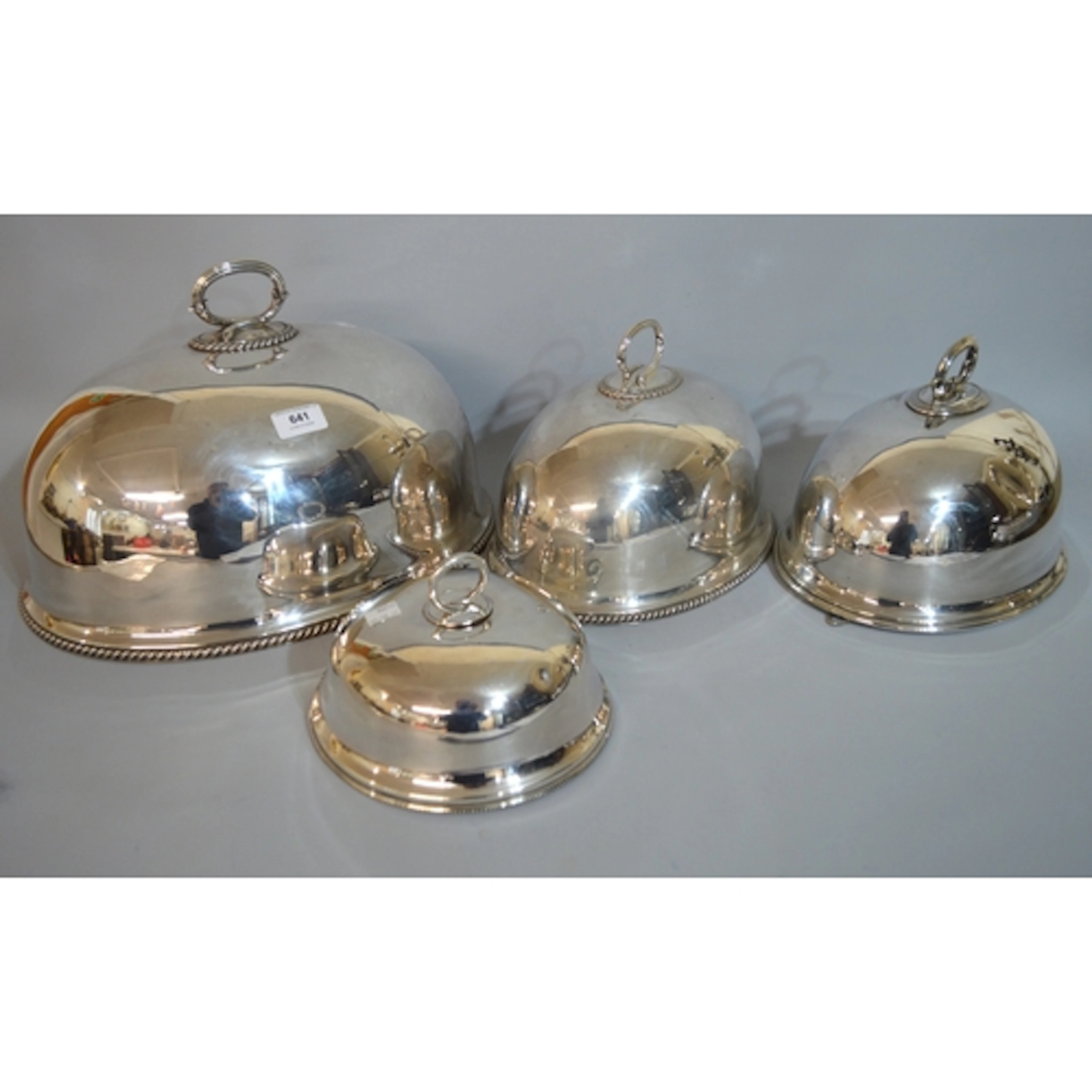 Two matching graduated silver plated meat dish covers with h...