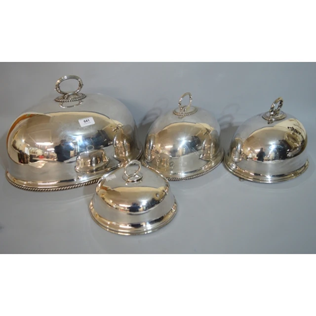 Two matching graduated silver plated meat dish covers with h...