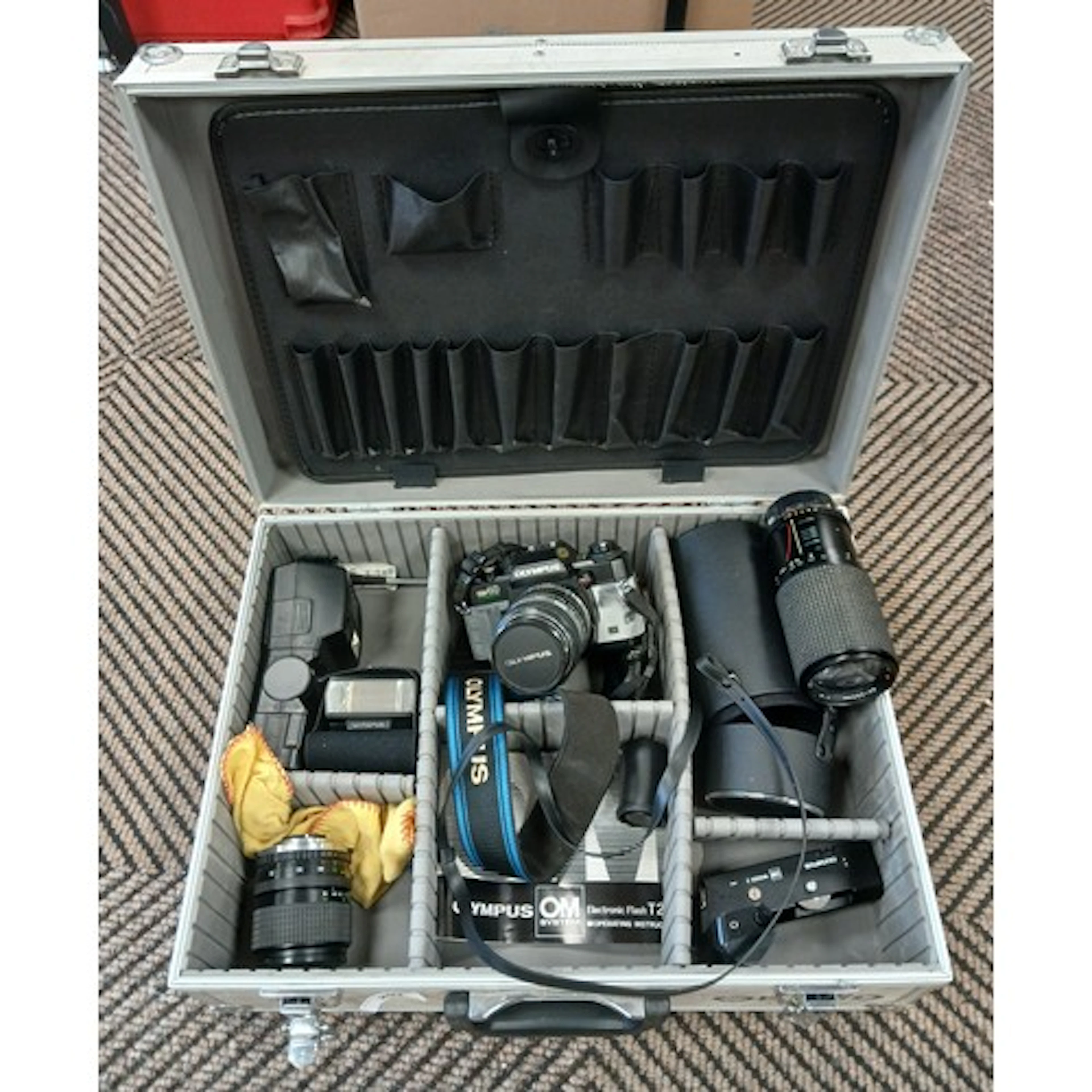 Olympus OM40 camera, various lenses, flash gun, etc containe...