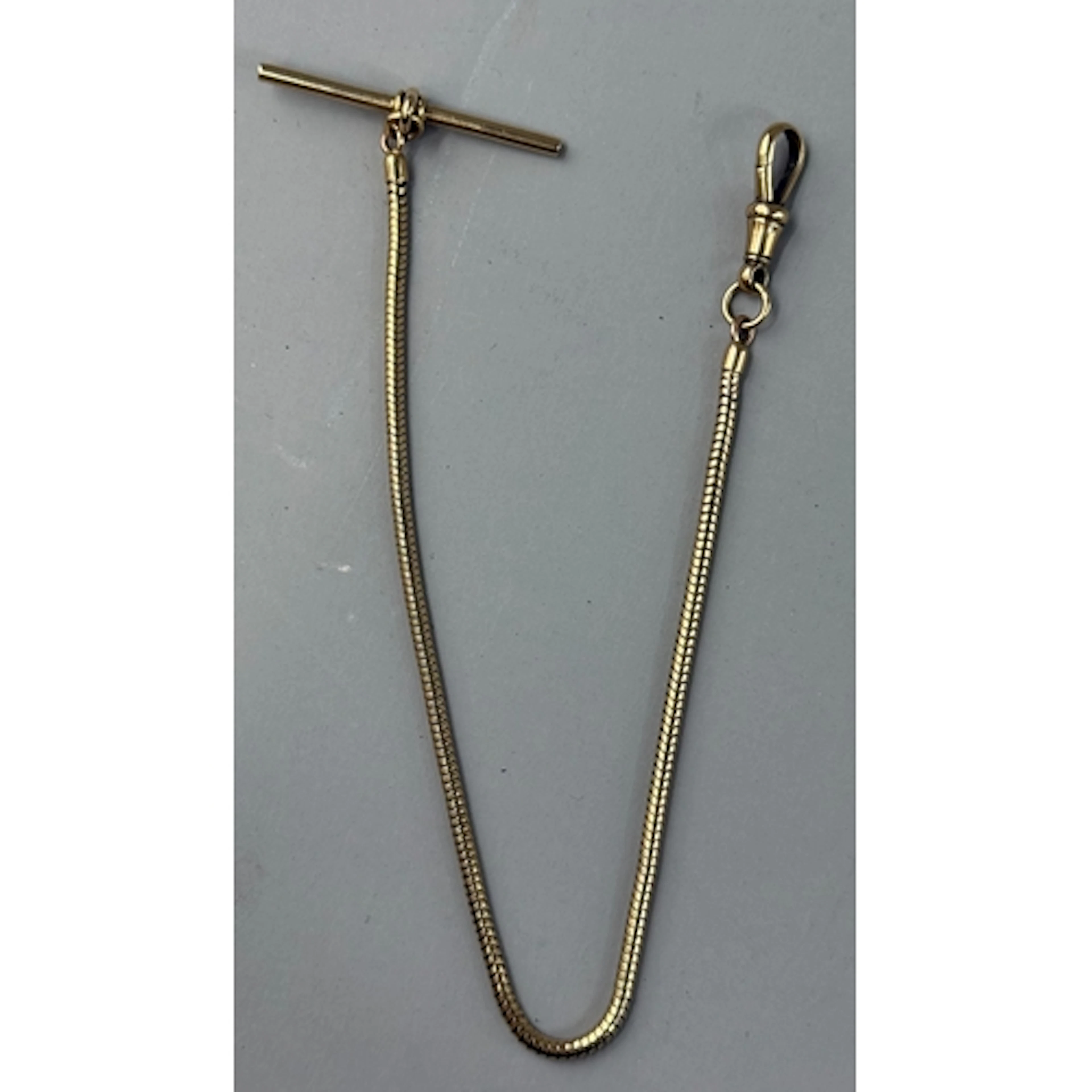 Jewellery: a yellow metal snake style pocket watch chain, ma...