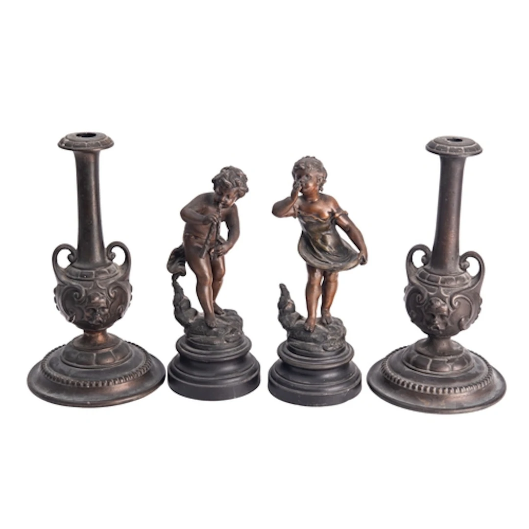 A pair of patinated metal candlesticks, early 20th century; ...