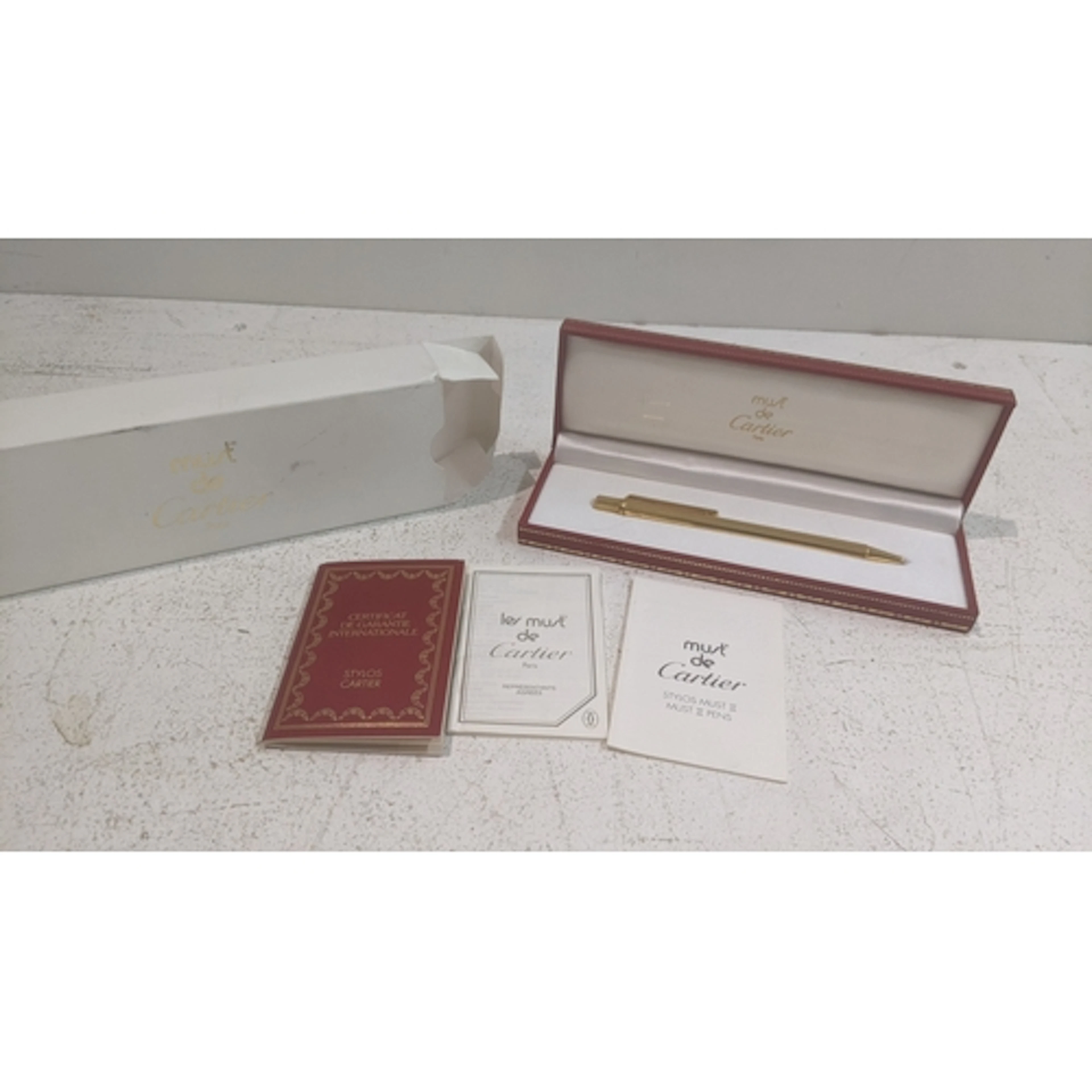 A boxed Cartier gold plated ballpoint pen with an Internatio...