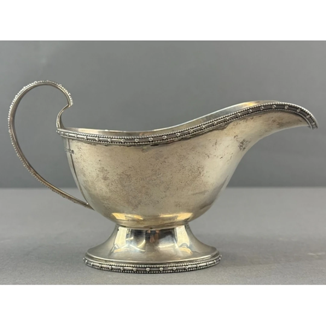 Silver: a pedestal sauce boat by Walker & Hall, Sheffiel...