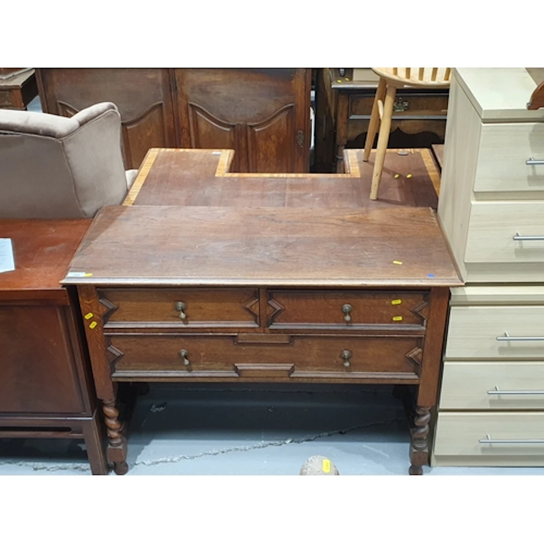 An oak sideboard fitted two short above one long drawer rais...