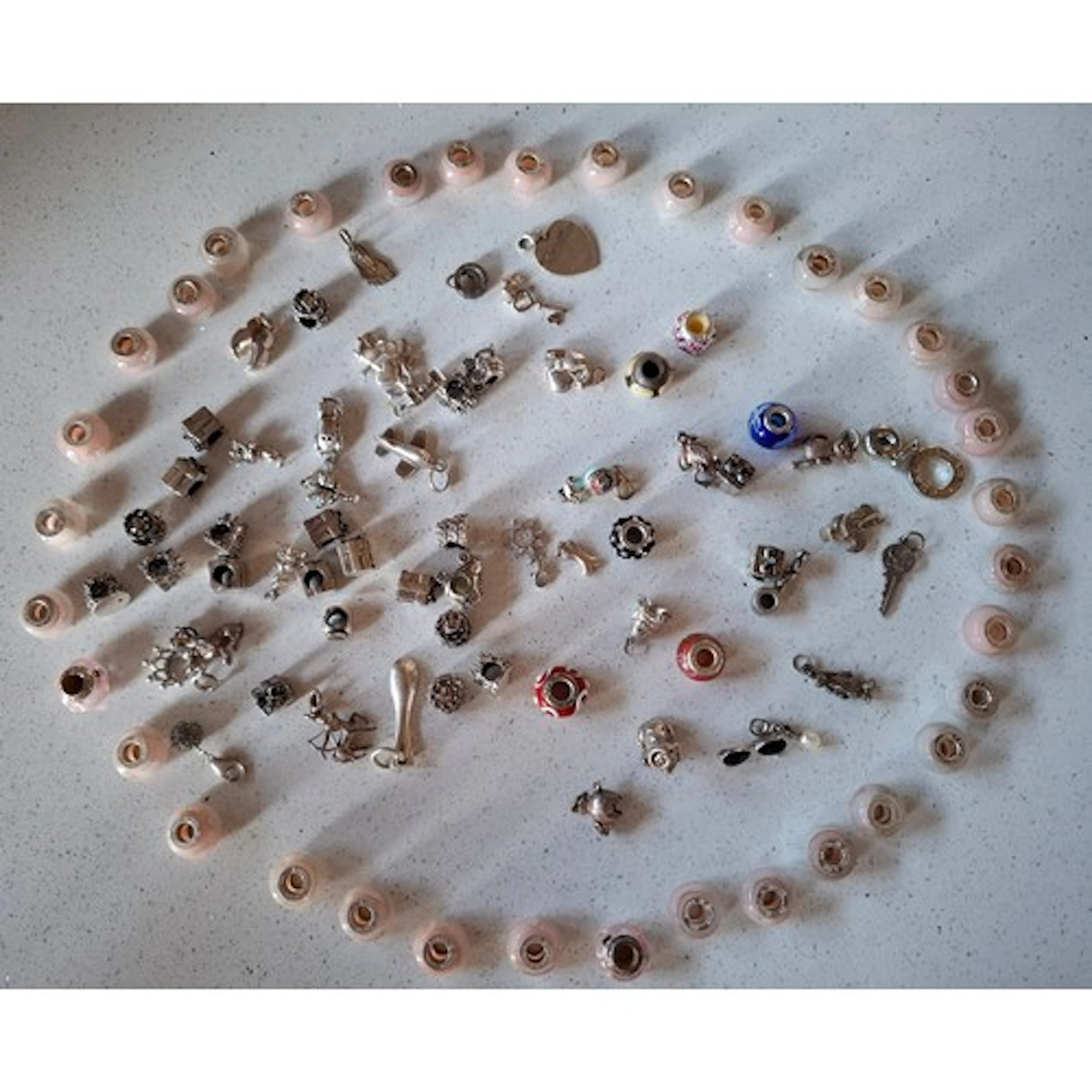 A collection of charms comprising 34 x Rhone Sutton pink gla...