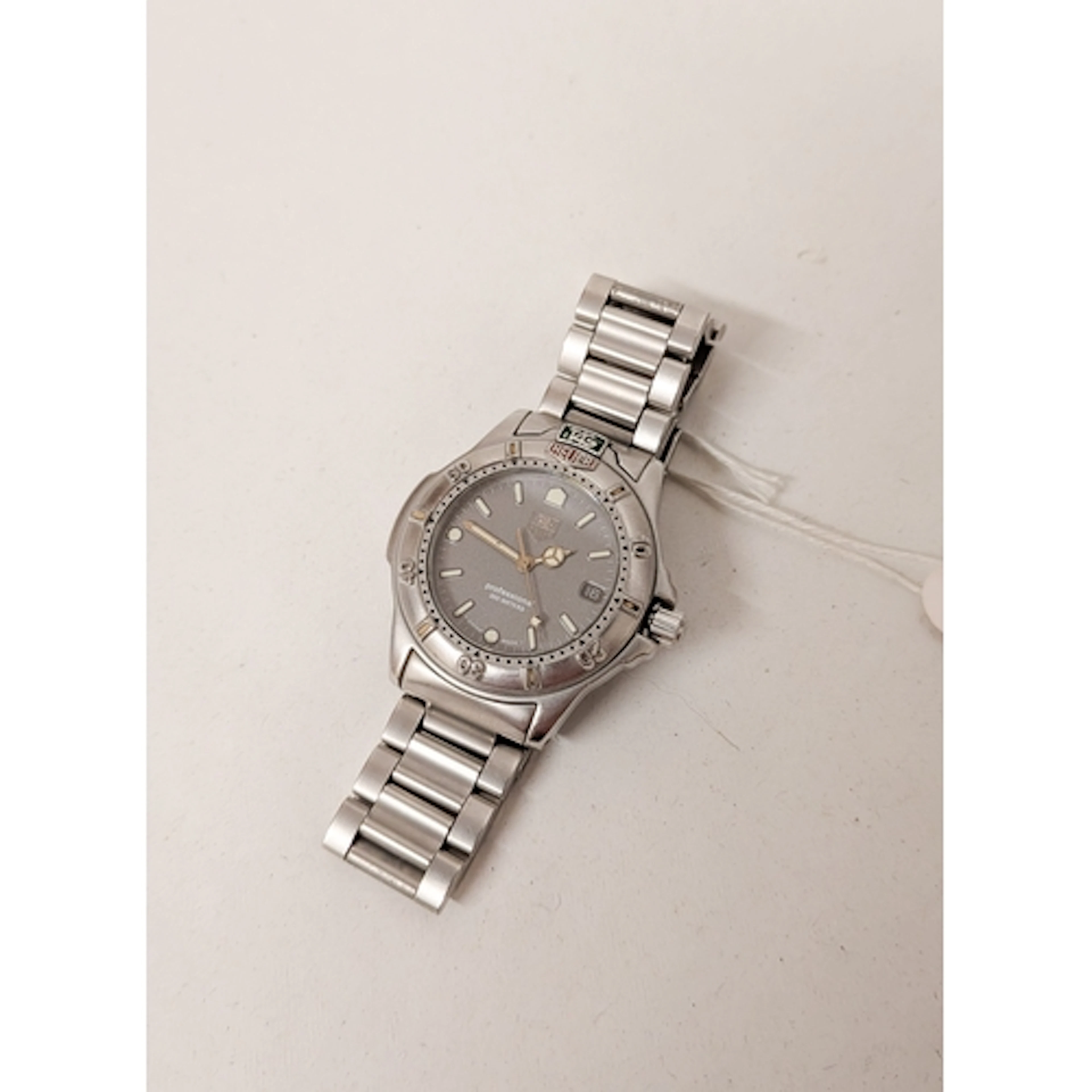 Tag Heuer - midsize professional quartz date wristwatch on a...