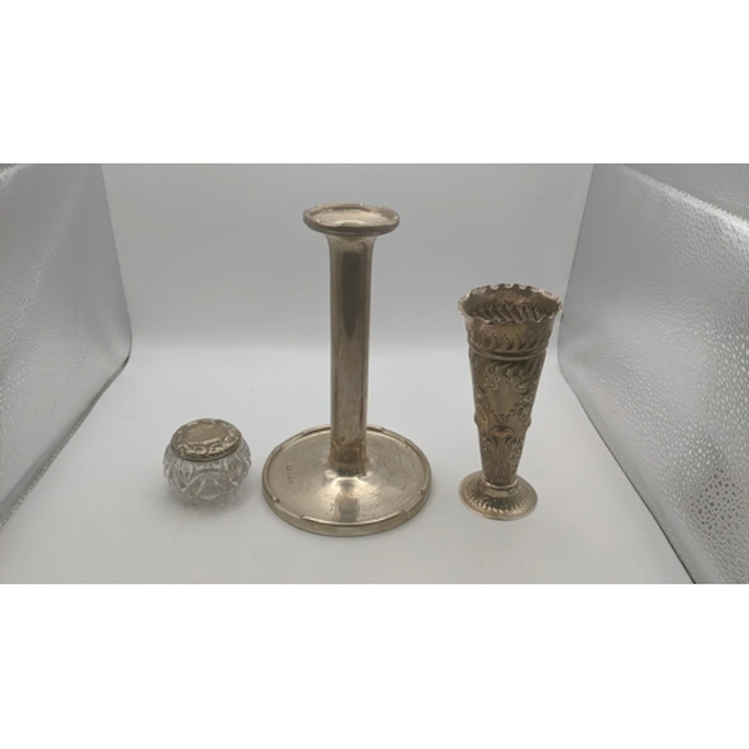 Silver to include a weighted candlestick, an embossed vase a...