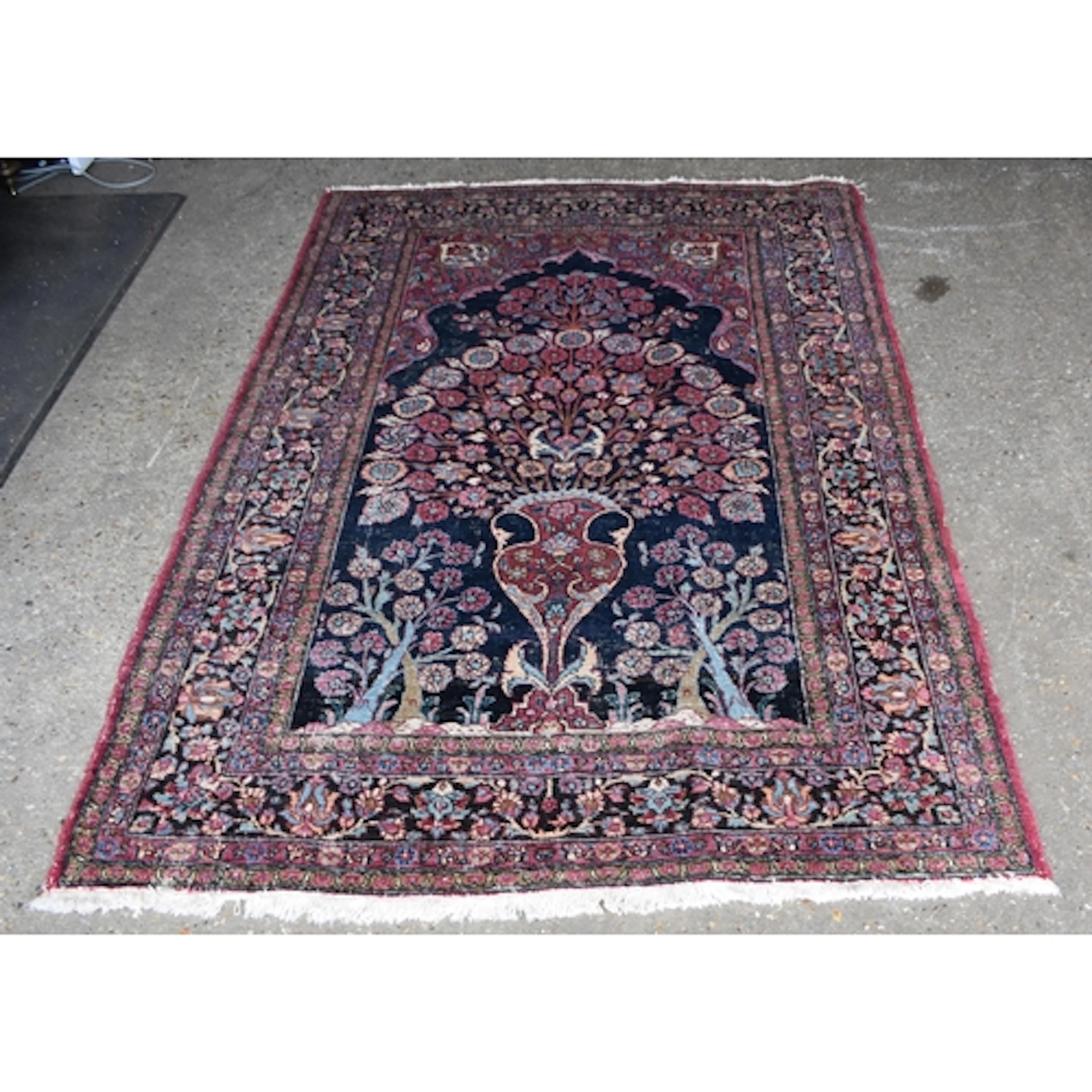 An antique Persian Mashad rug 201 x 140cm