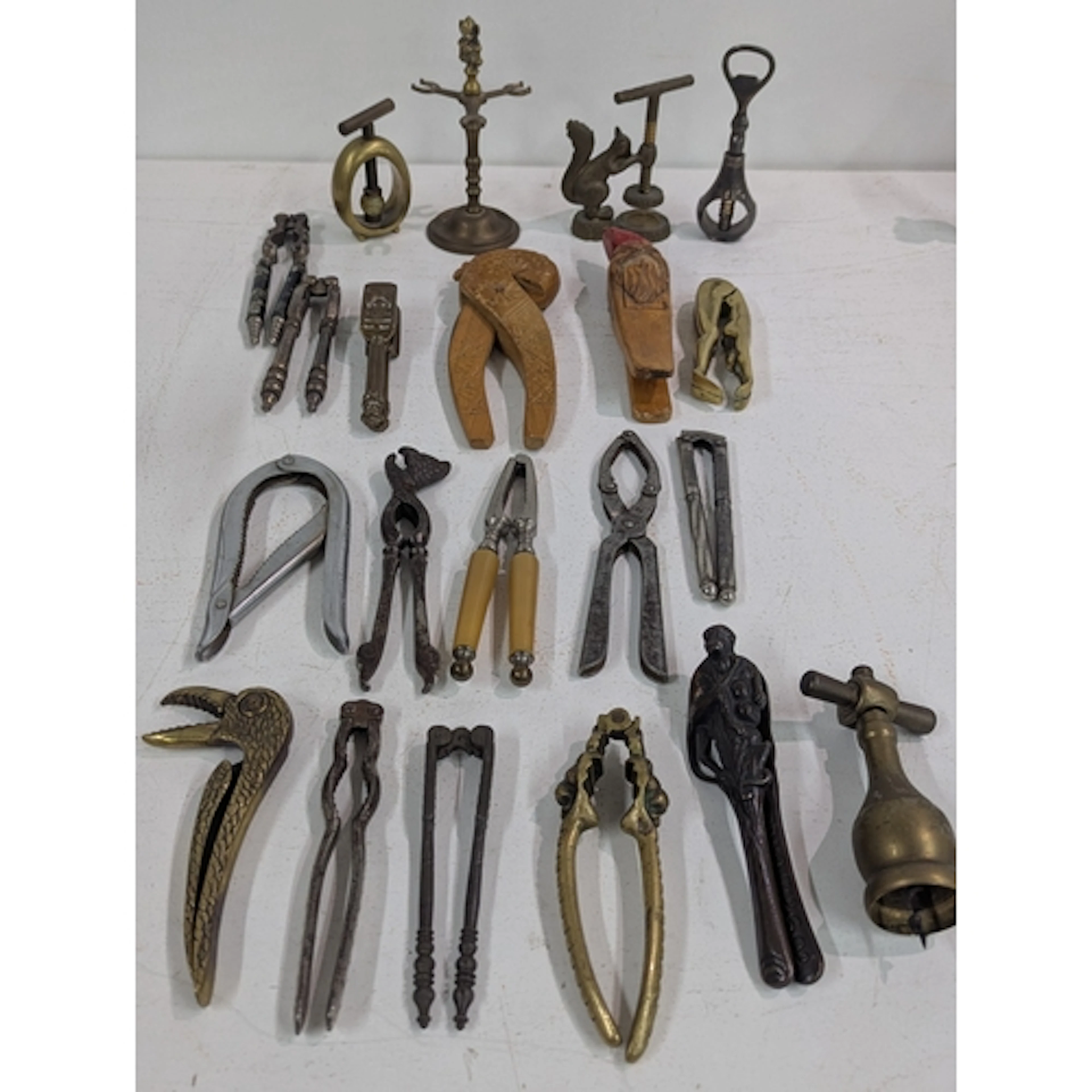 A collection of vintage nut crackers to include a brass squi...