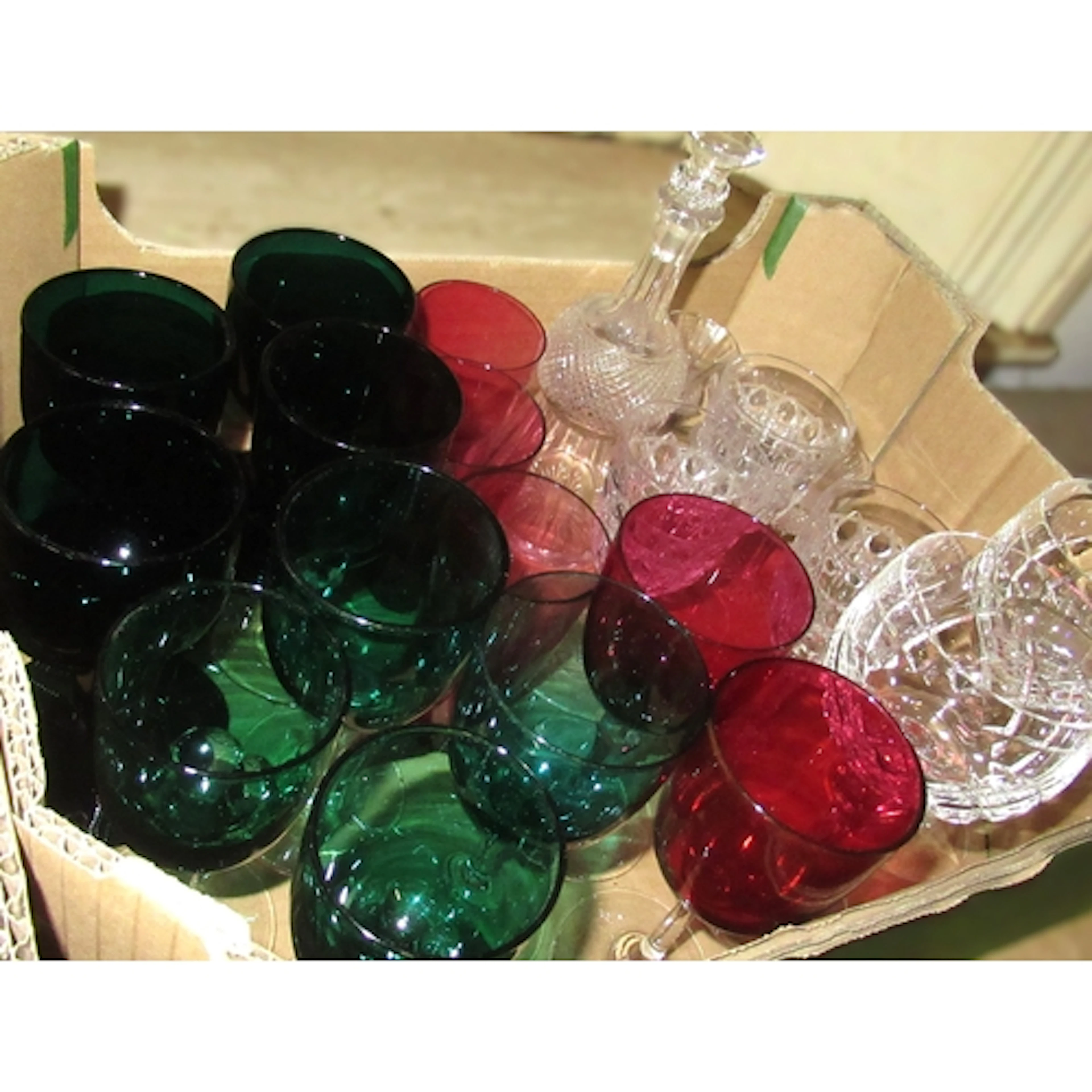 Group of various green, cranberry and clear cut drinking gla...