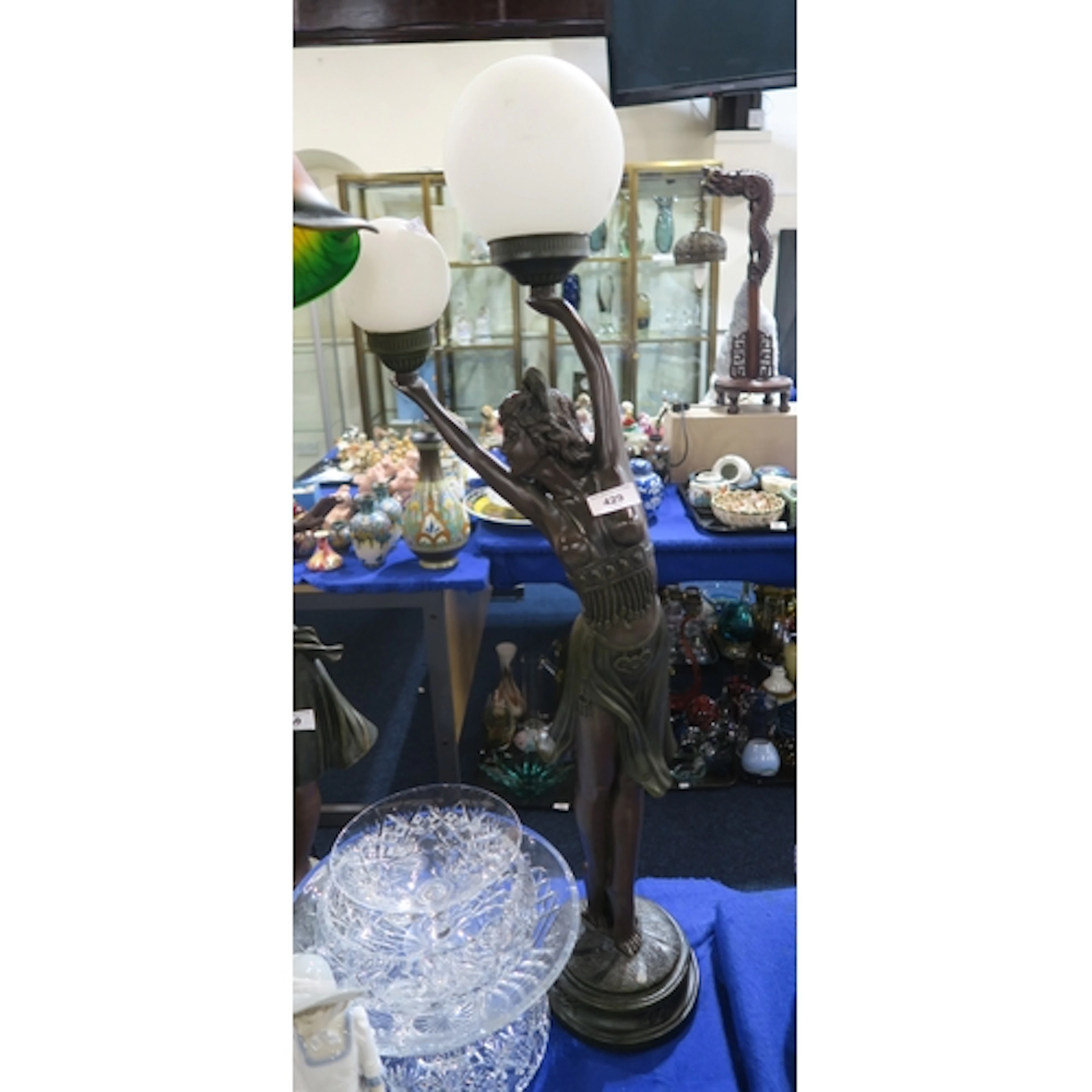 An Art Deco style table lamp modelled as a girl balancing tw...