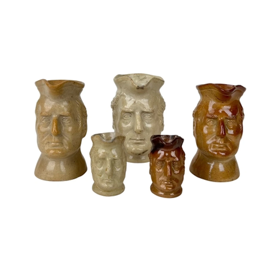 A GROUP OF ENGLISH 19TH CENTURY STONEWARE CHARACTER JUGS DEP...