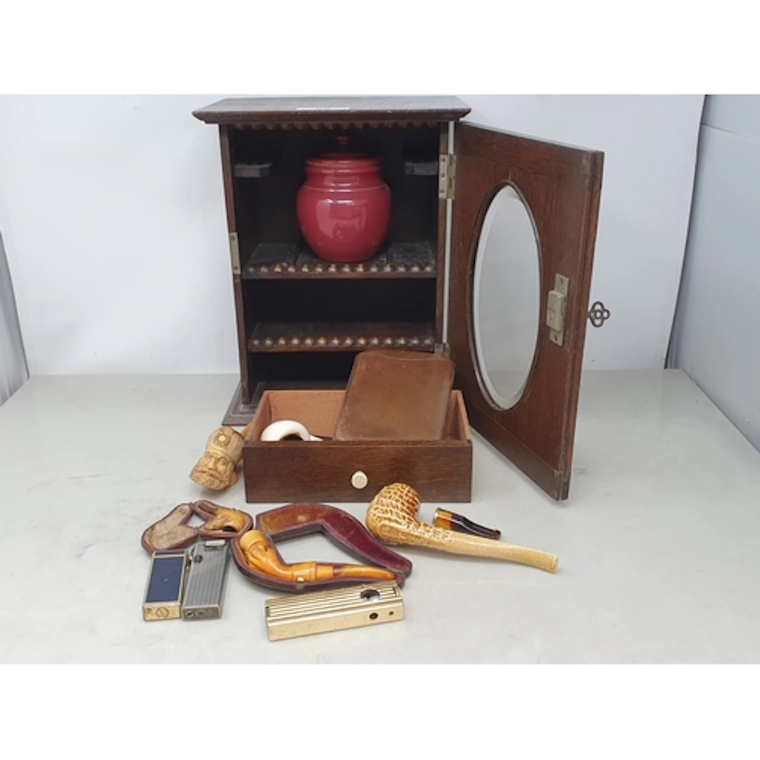 An oak Smoker's Cabinet with oval glazed panelled door enclo...