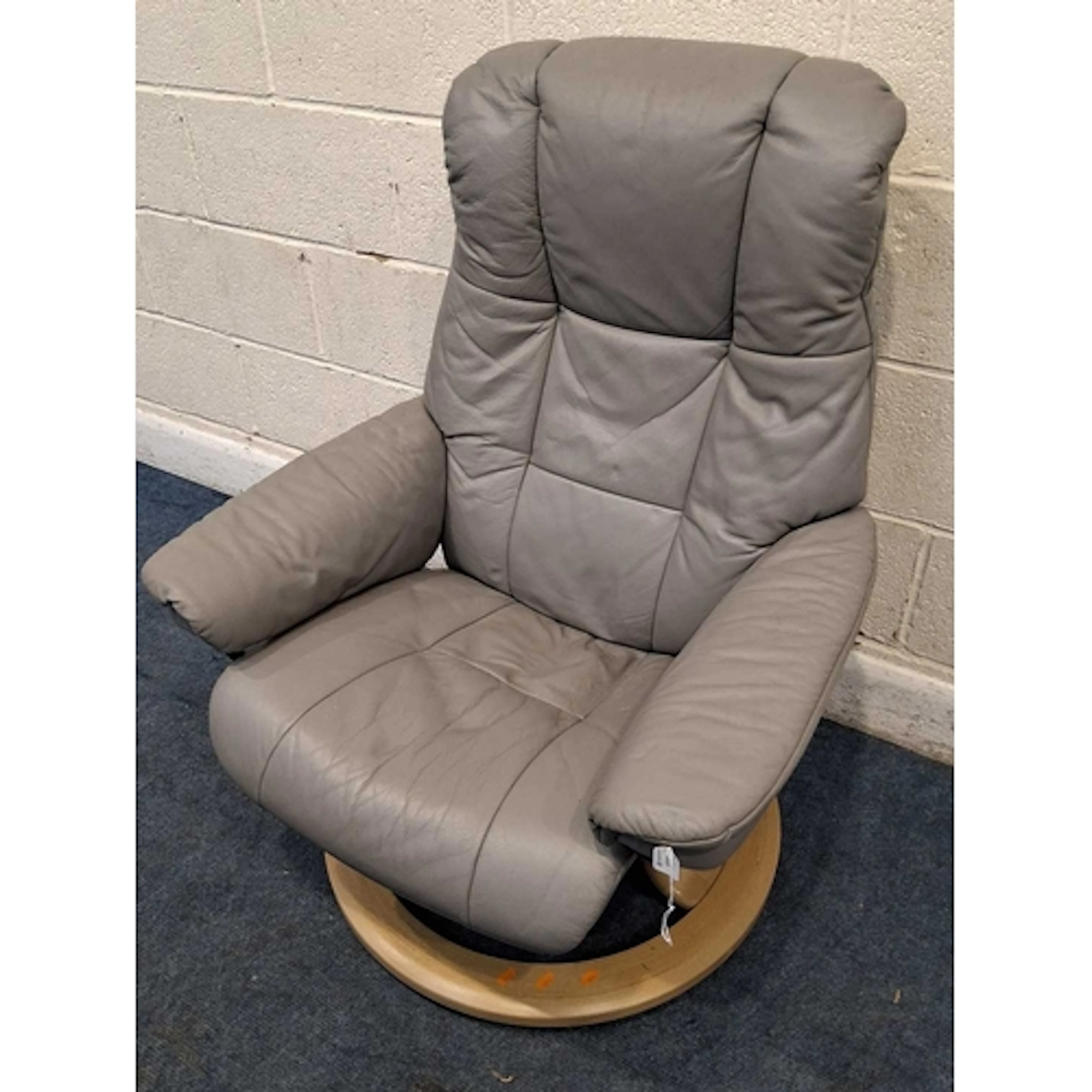 AN EKORNES STRESSLESS GREY LEATHER SWIVEL RECLINING ARMCHAIR...