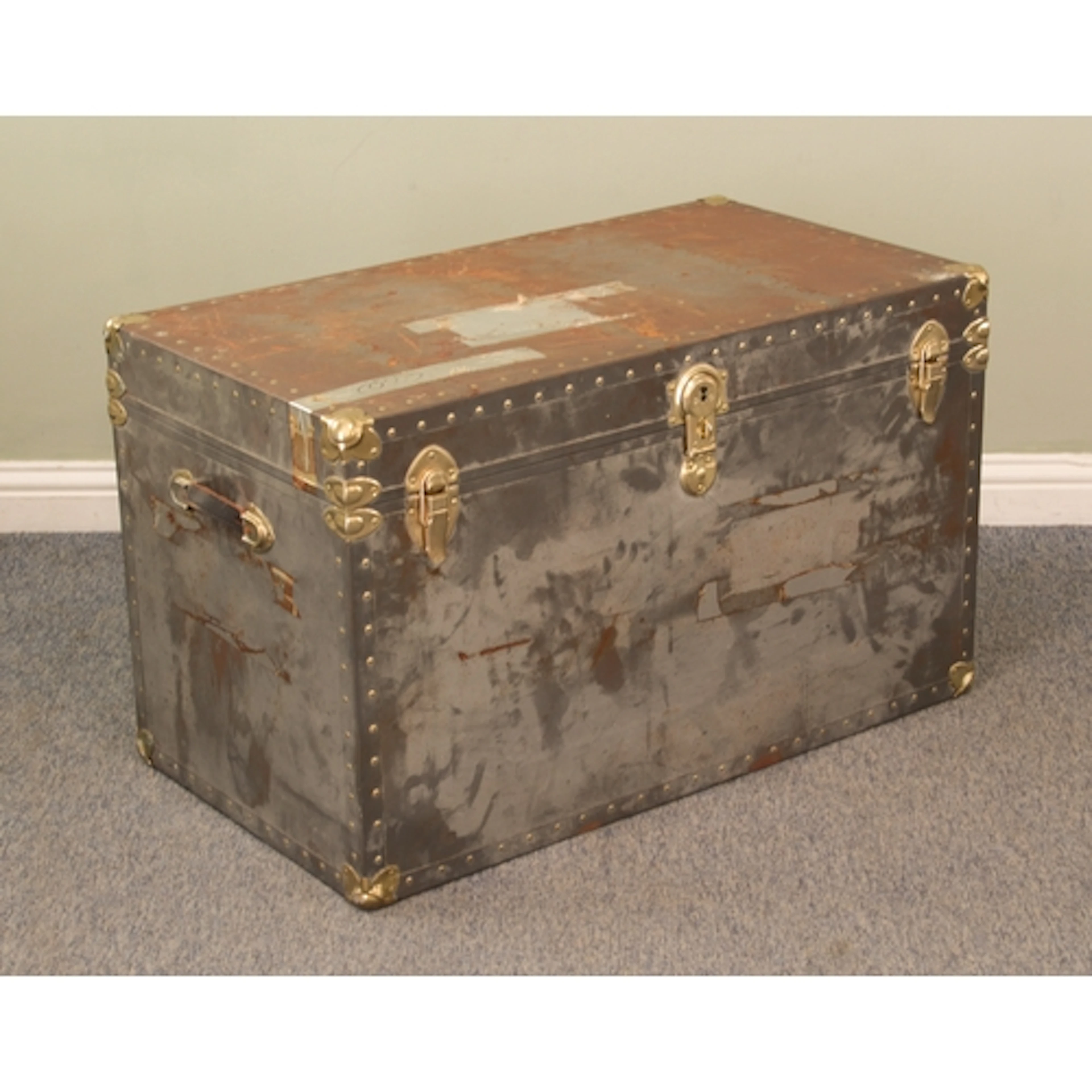 A large polished metal steamer or school trunk - with gold t...