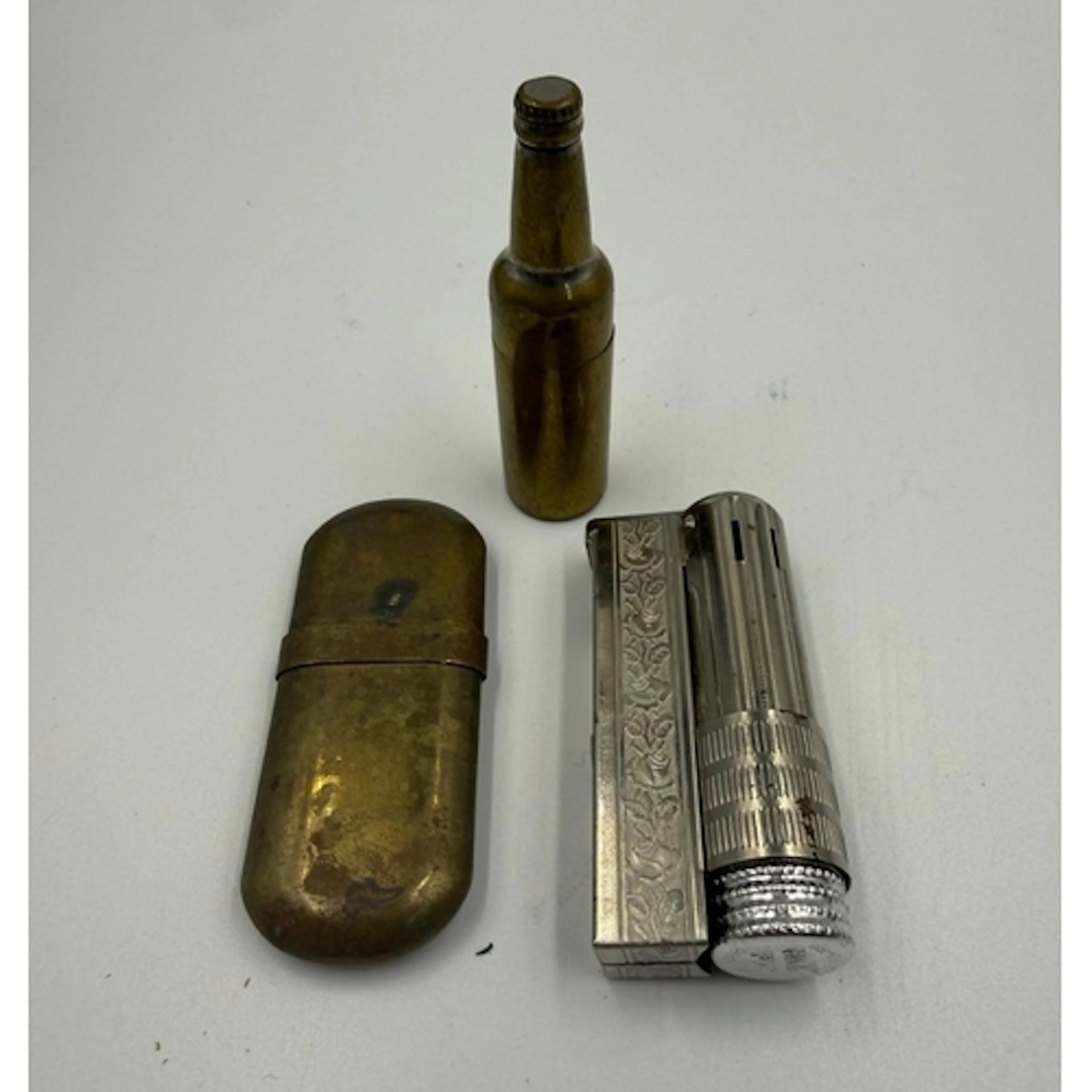 A selection of vintage lighters. One brass and in the form o...