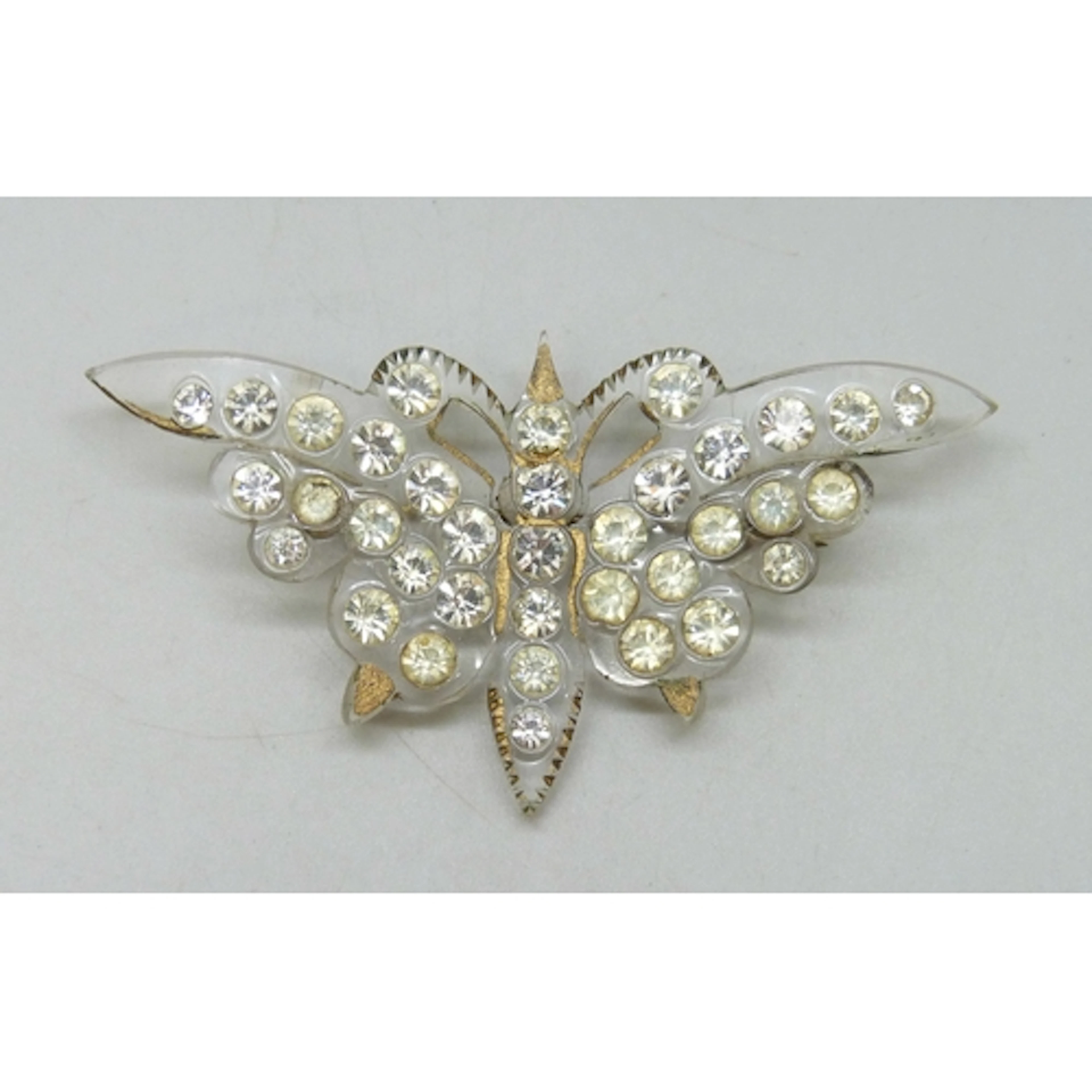 An Art Deco early plastic paste set butterfly brooch, 7.5cm