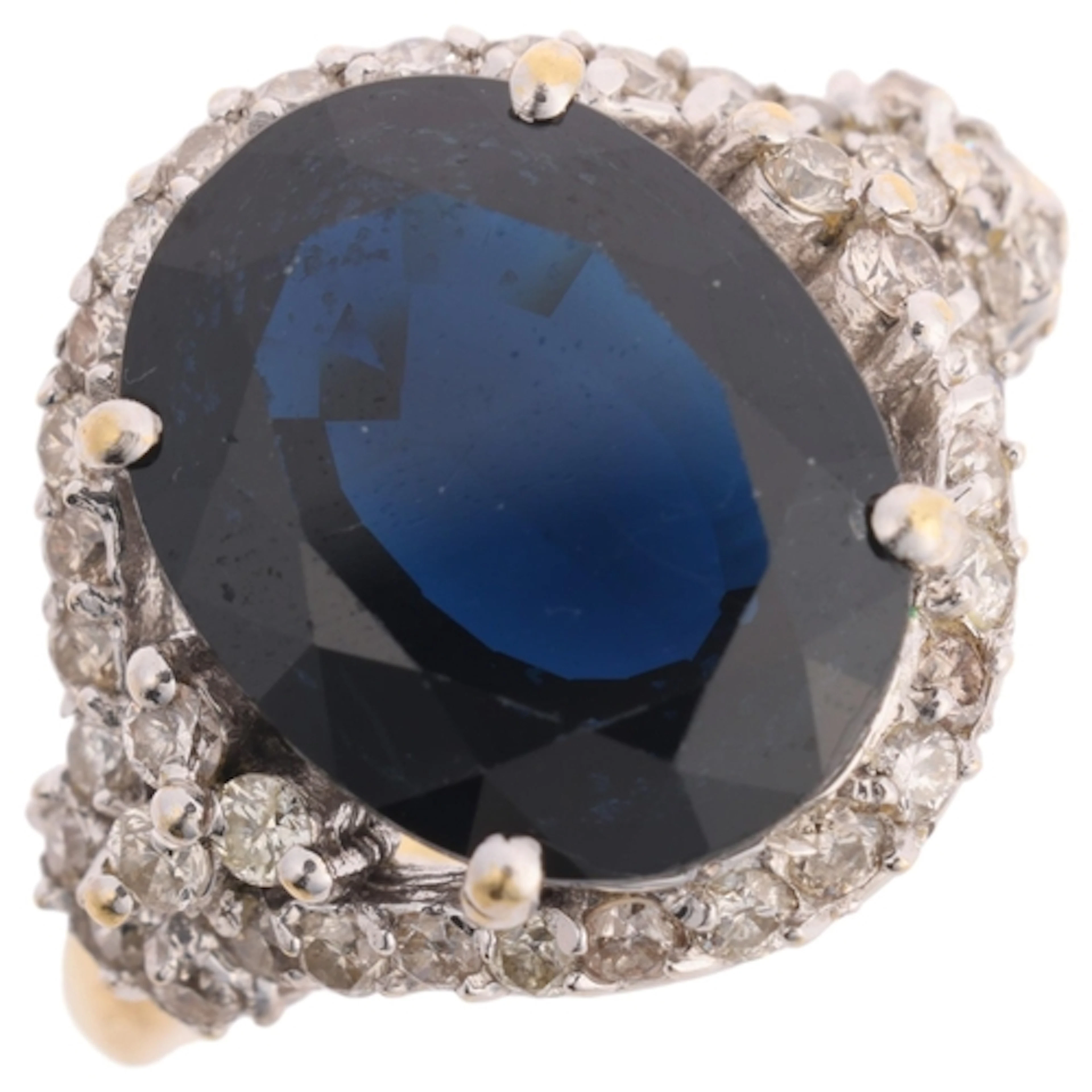 An 18ct gold sapphire and diamond cluster ring, claw set wit...
