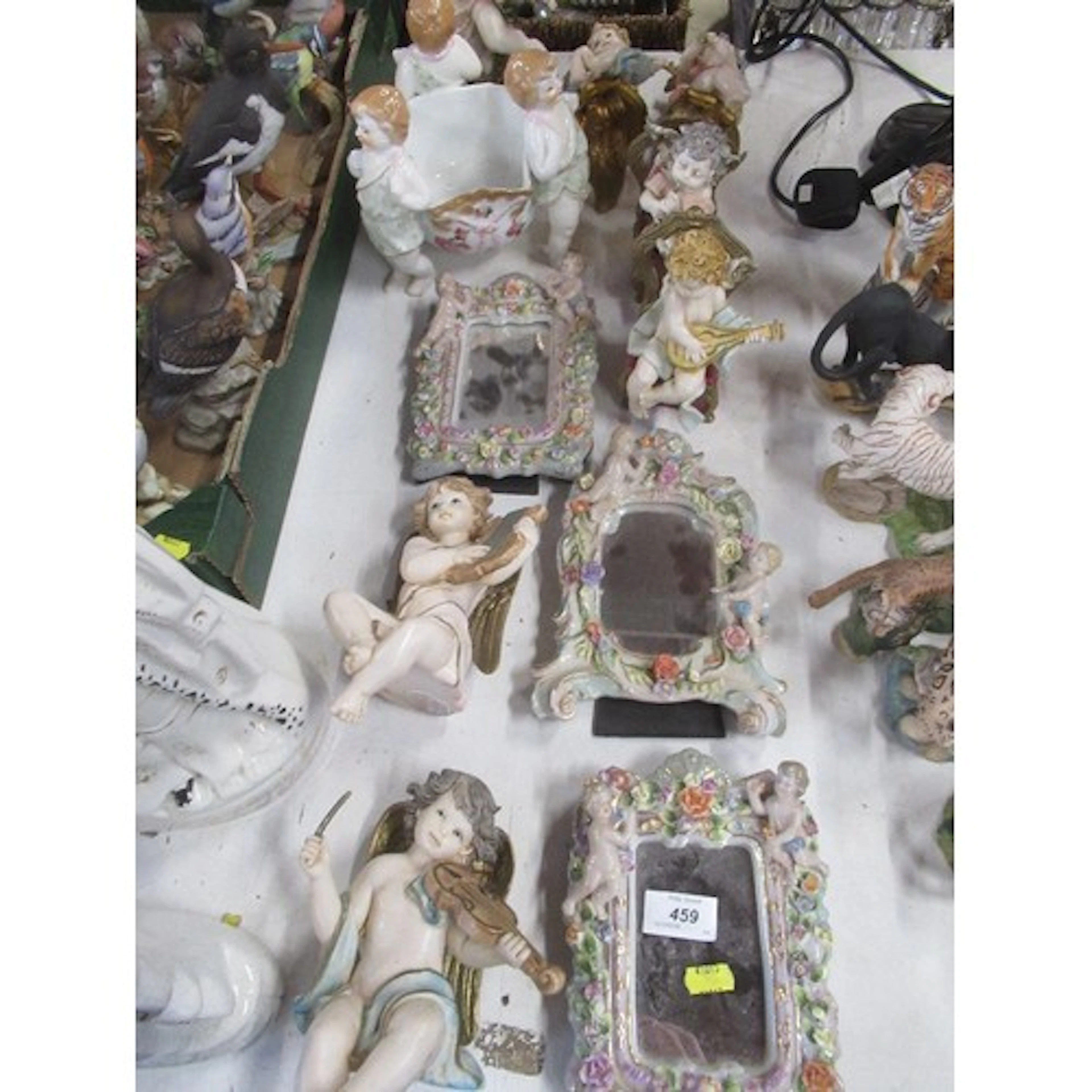 A collection of continental cherub models including mirrors