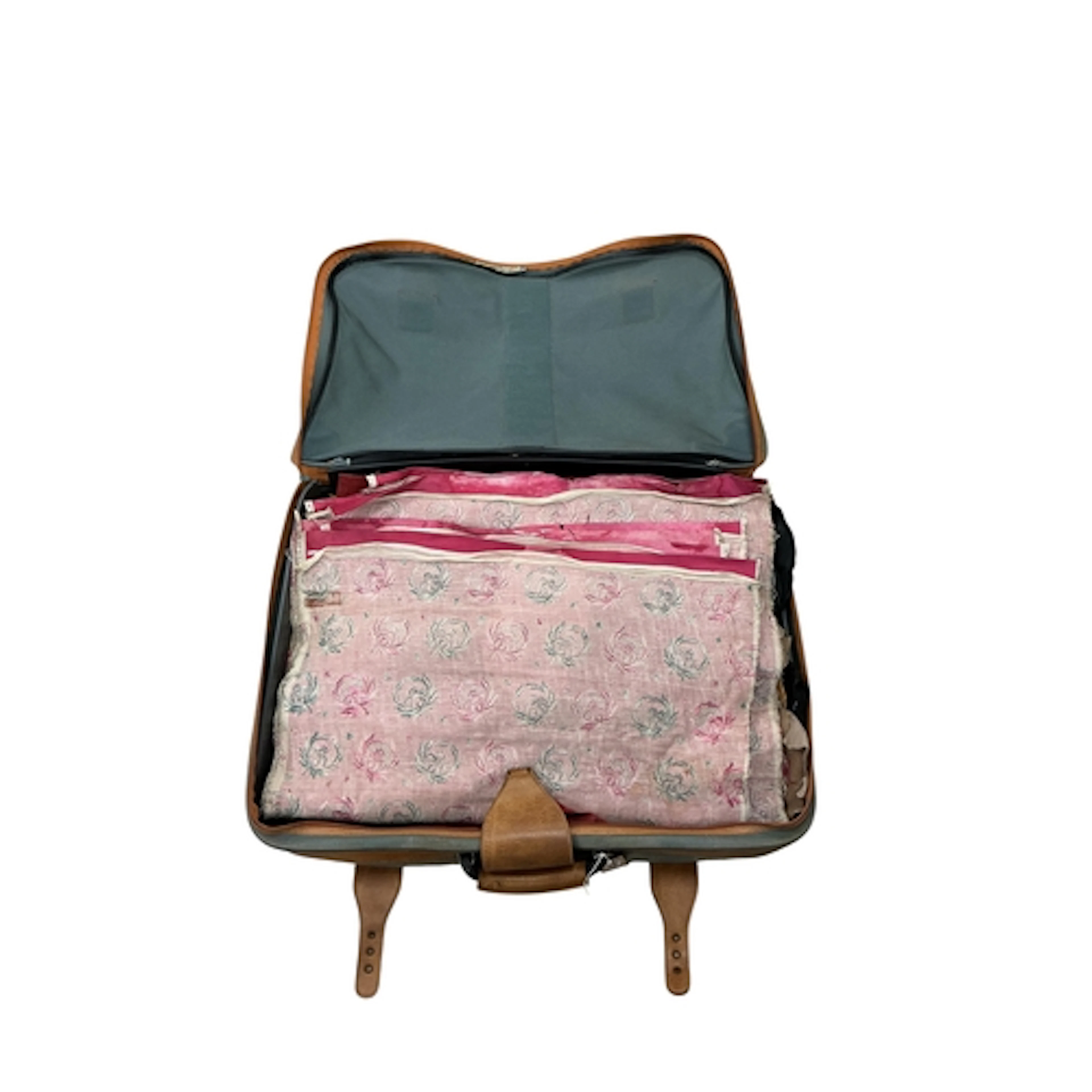 Assorted leathers and printed textiles, housed in a suitcase