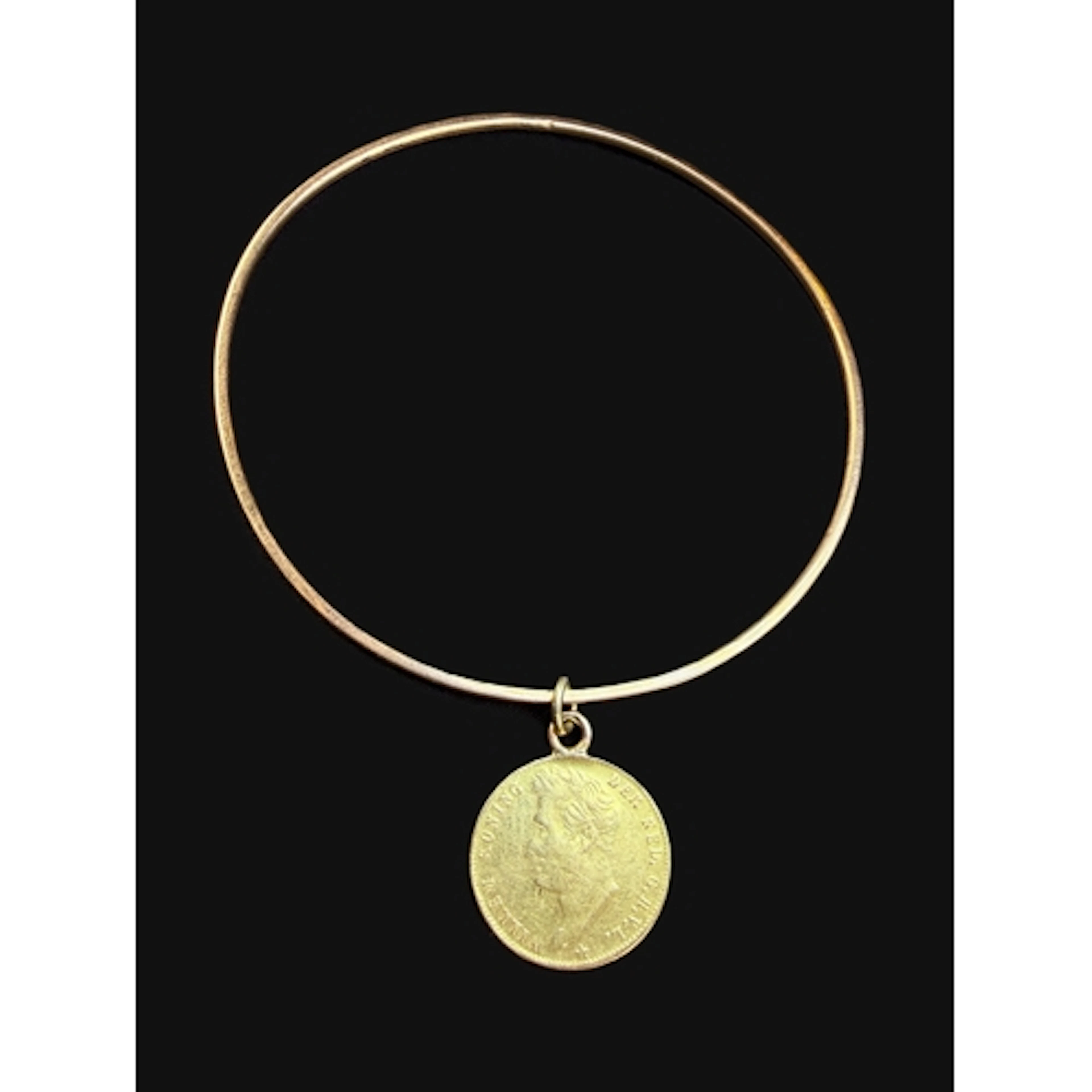 A 1826 Guilder Dutch coin attached to a yellow metal bracele...