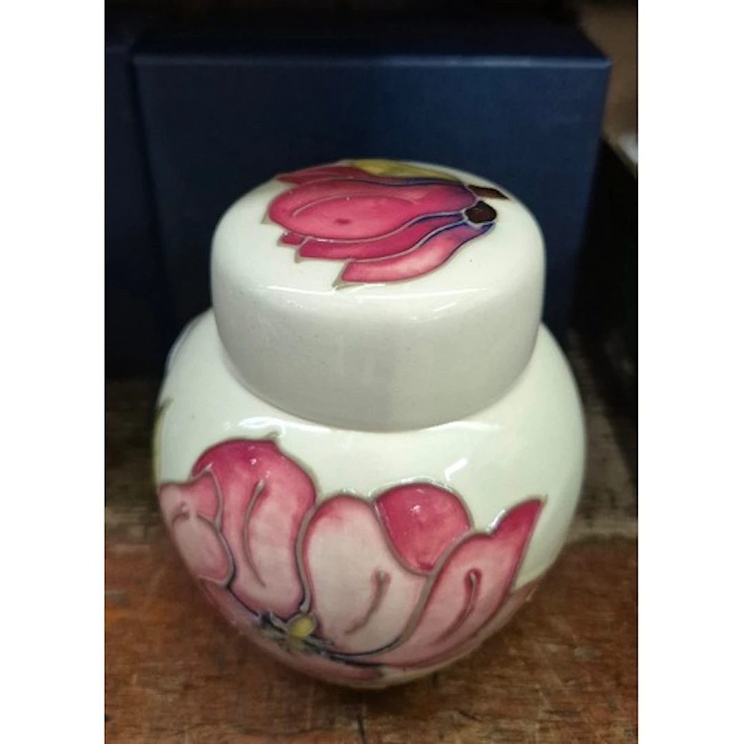A small Moorcroft ginger jar, Magnolia pattern on cream grou...