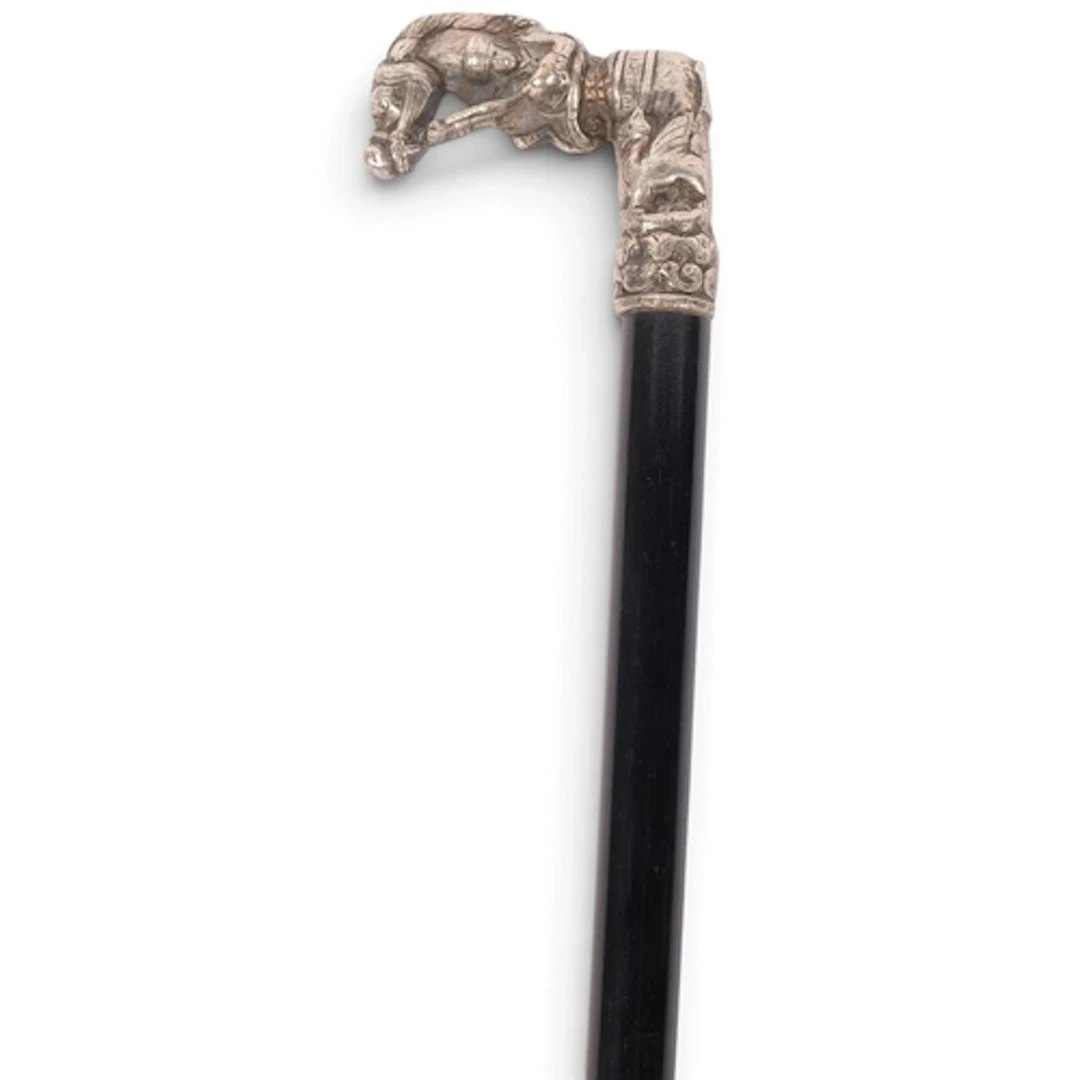A late 19th century walking cane with white metal horse hand...