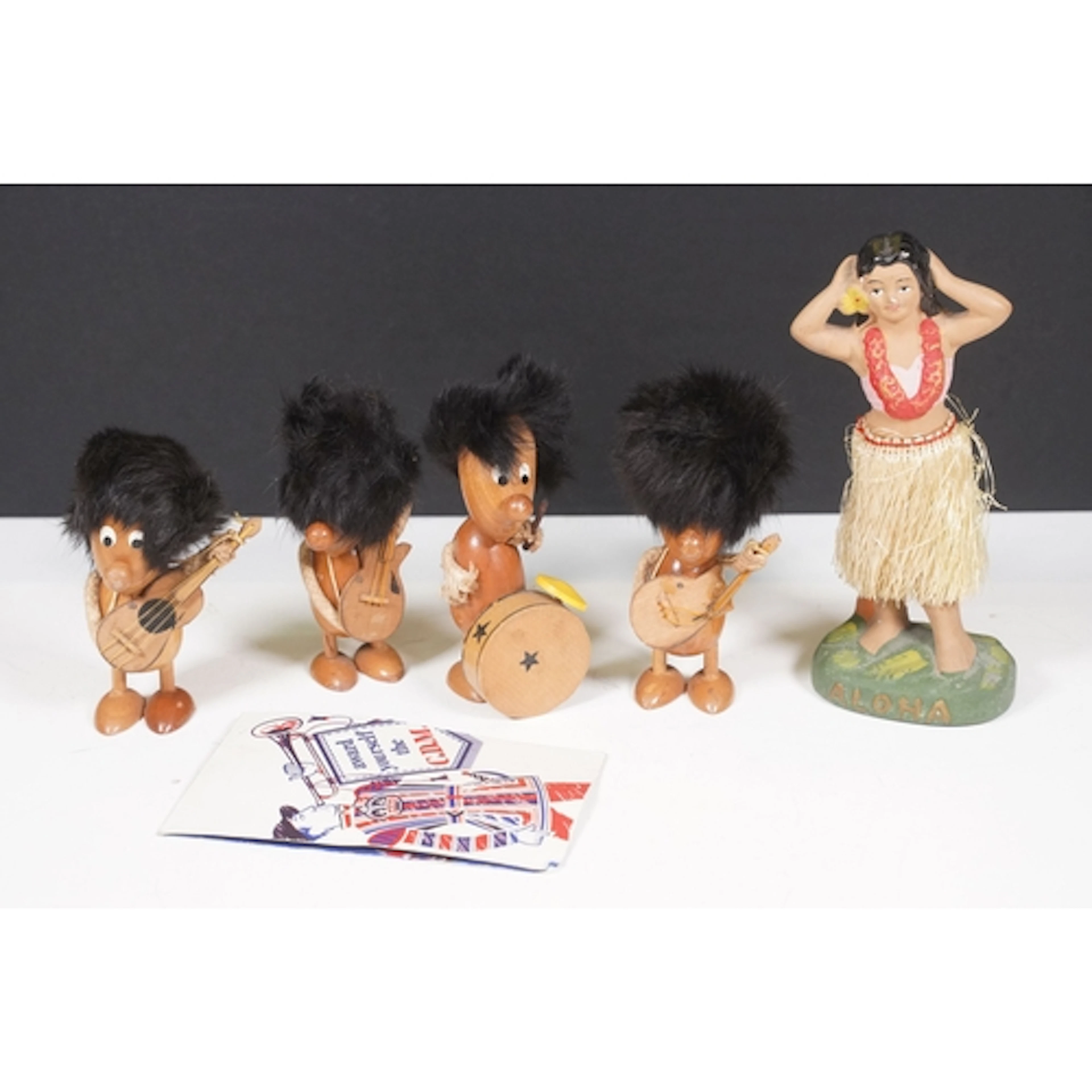 Four Daysun folk art wooden figurines of a band, each with D...