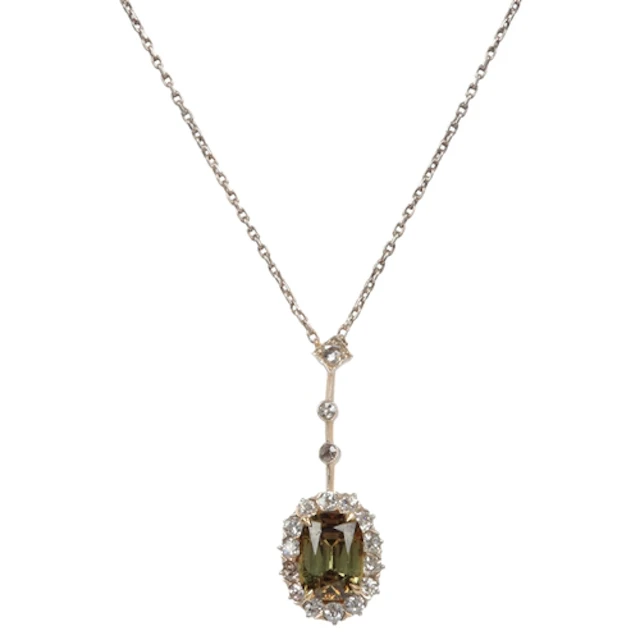 A demantoid garnet and diamond pendant, claw-set with an ova...