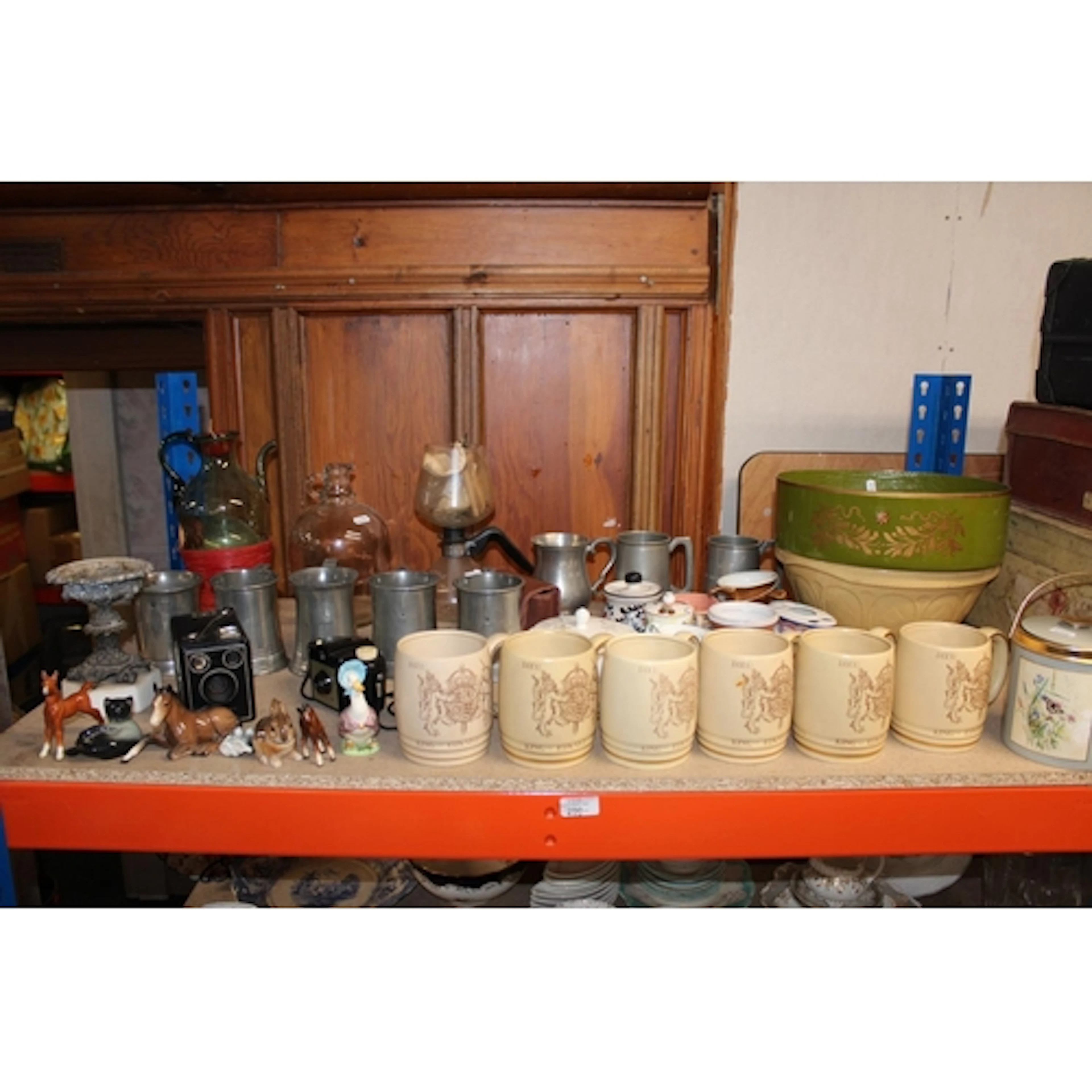 Shelf containing pewter tankards, Beswick horses, Beatrix Po...