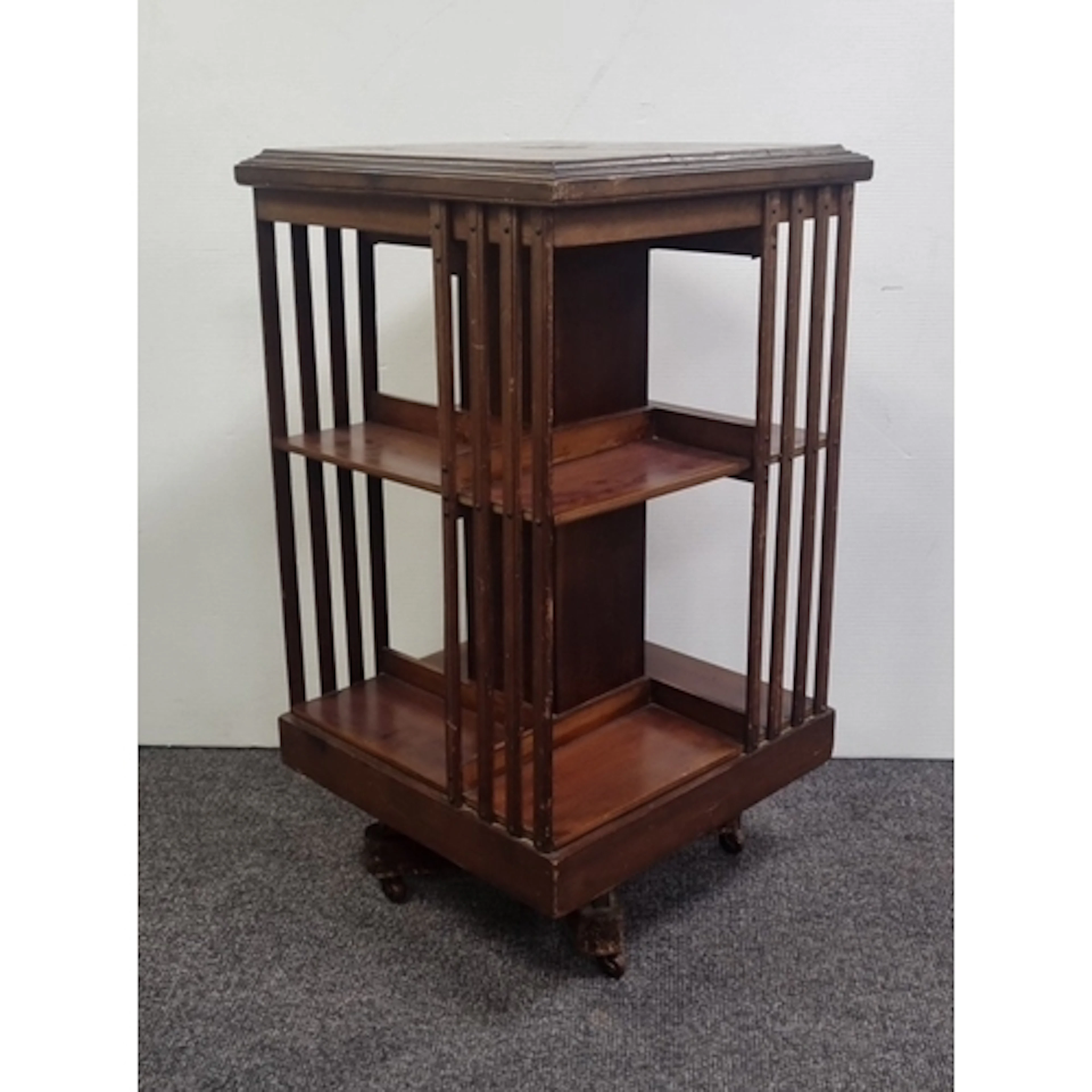 Mahogany octagonal revolving bookcase on castors