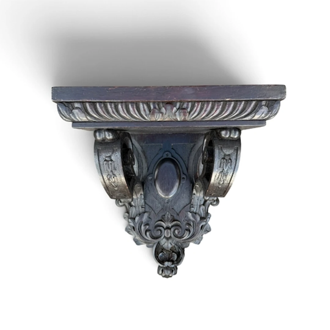 A BAROQUE REVIVAL CARVED OAK WALL BRACKET The scrolled suppo...