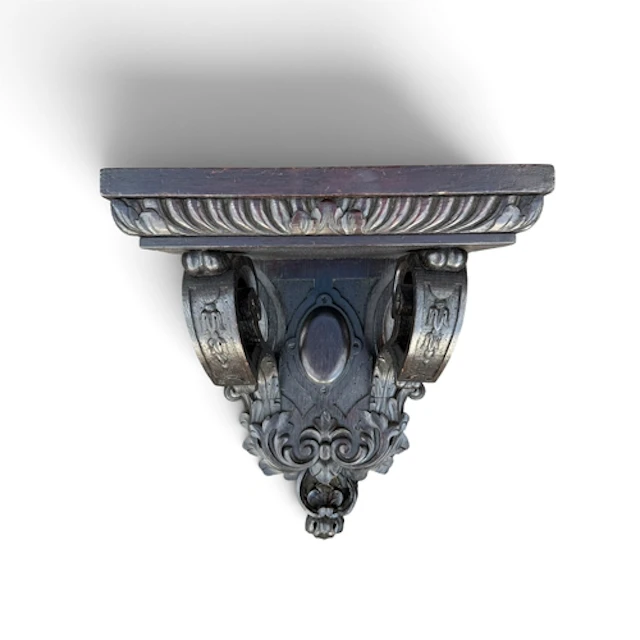 A BAROQUE REVIVAL CARVED OAK WALL BRACKET The scrolled suppo...