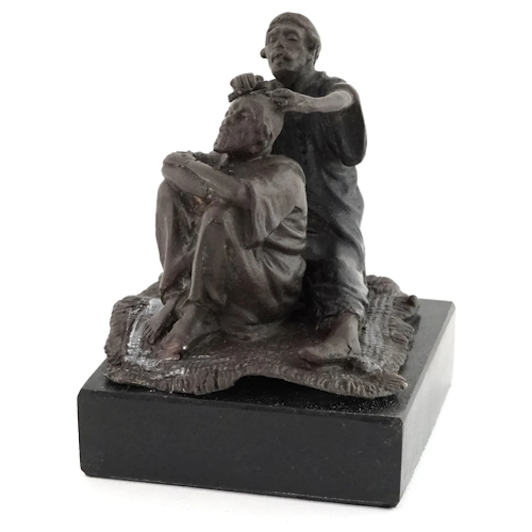 Patinated bronze figure group raised on a black marble base,...