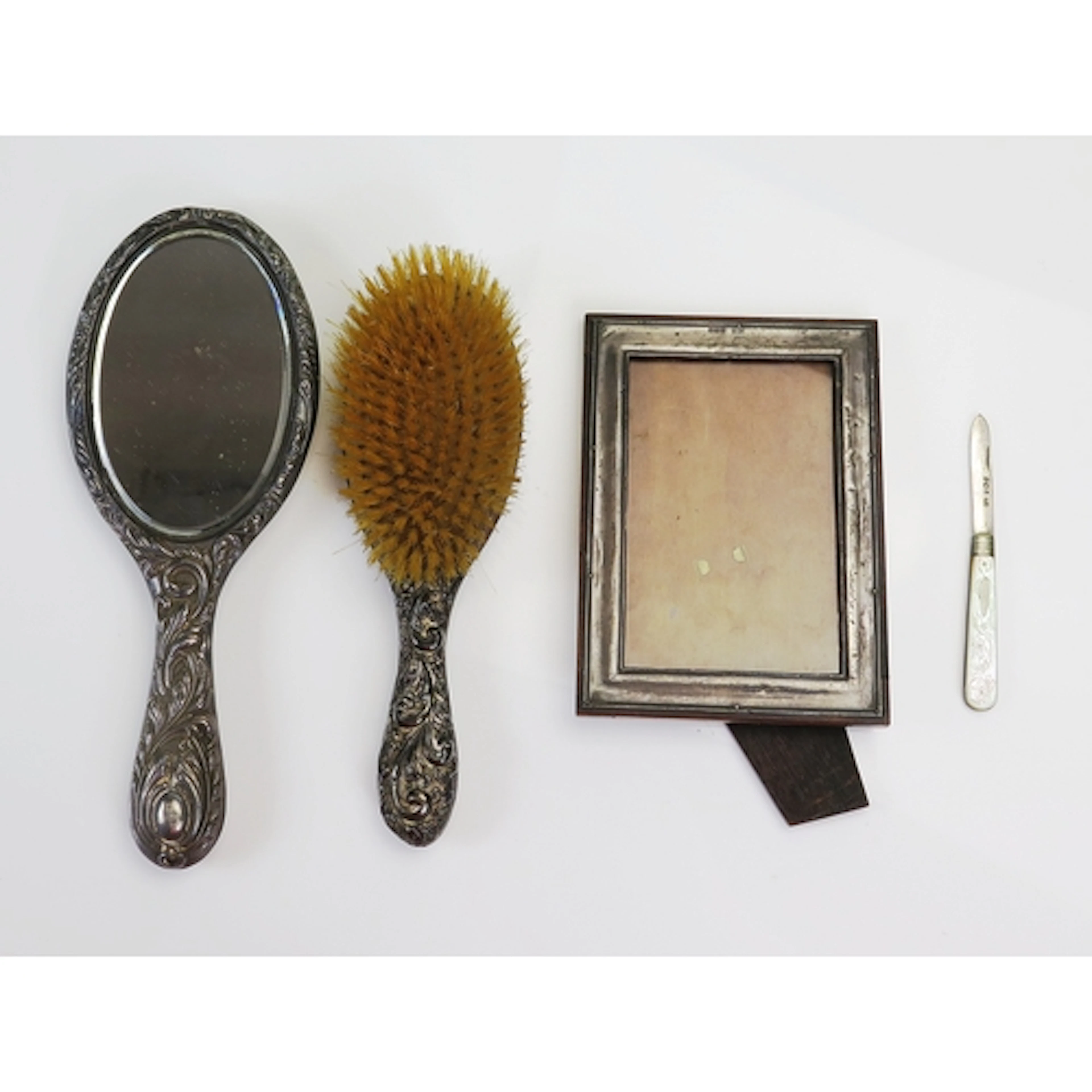Assorted silverwares to include a silver mounted hand mirror...