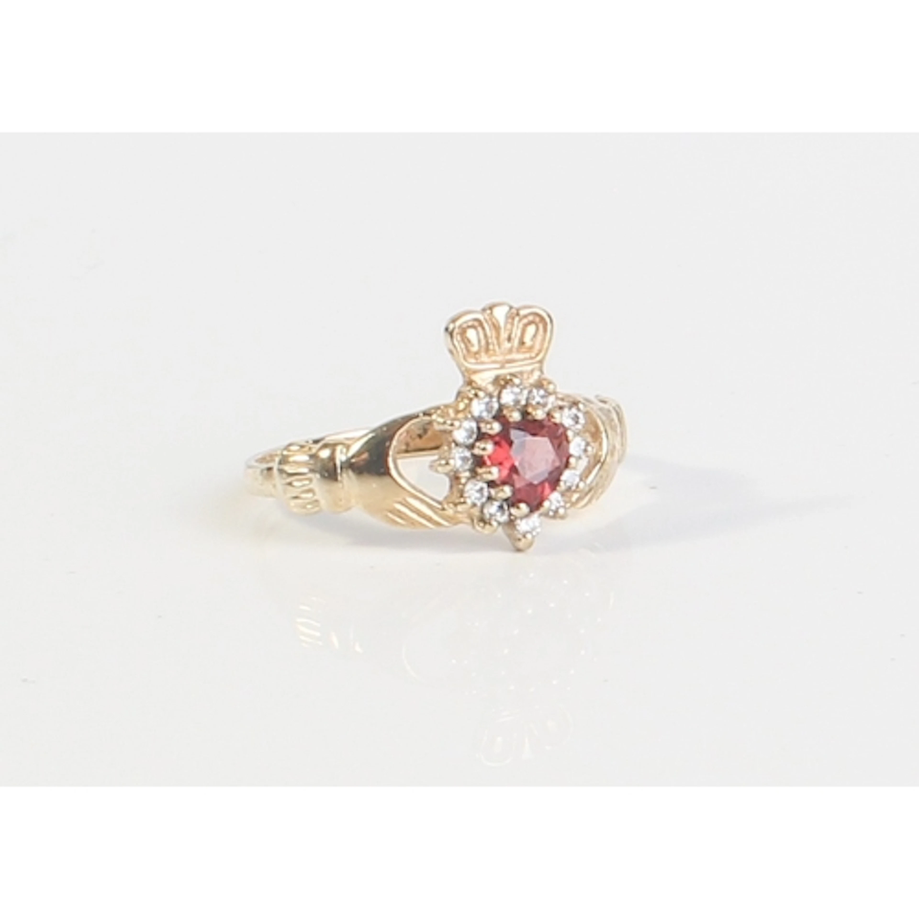 A 9ct yellow gold, garnet and white stone cluster Claddagh r...