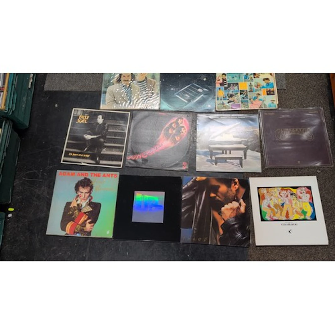 A collection of pop and rock vinyl records, including The Be...
