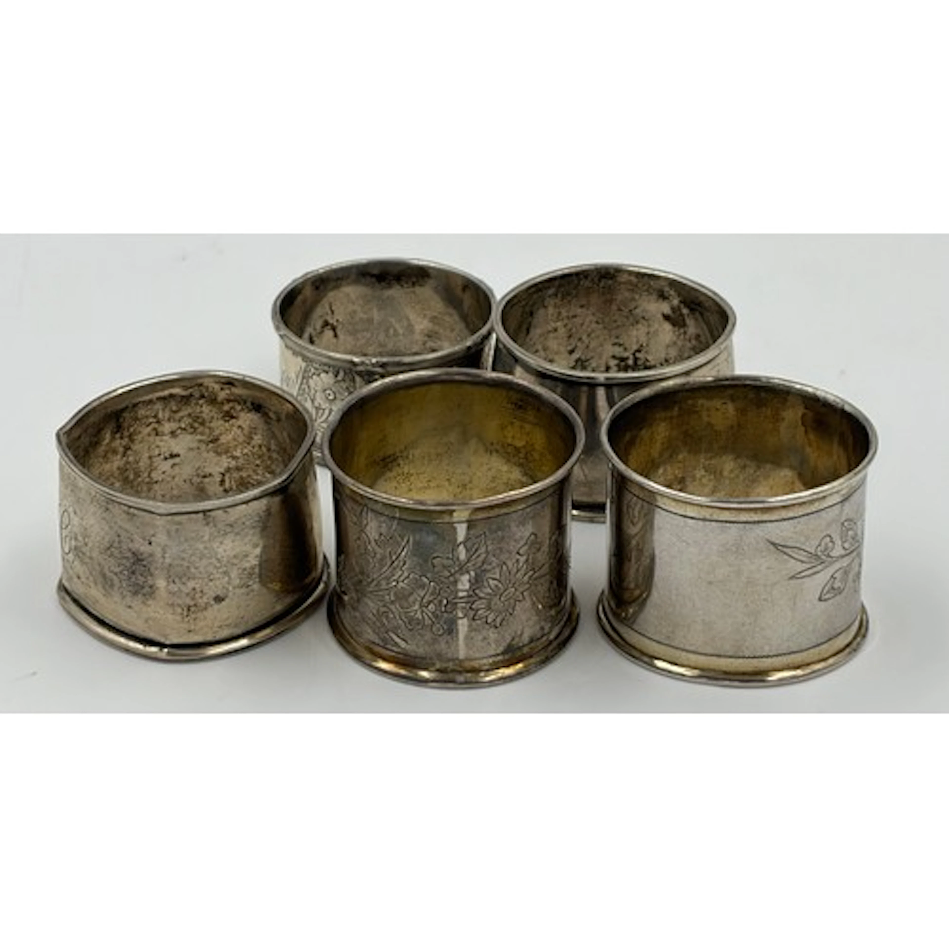 Five napkin rings, two hallmarked London, one hallmarked Bir...