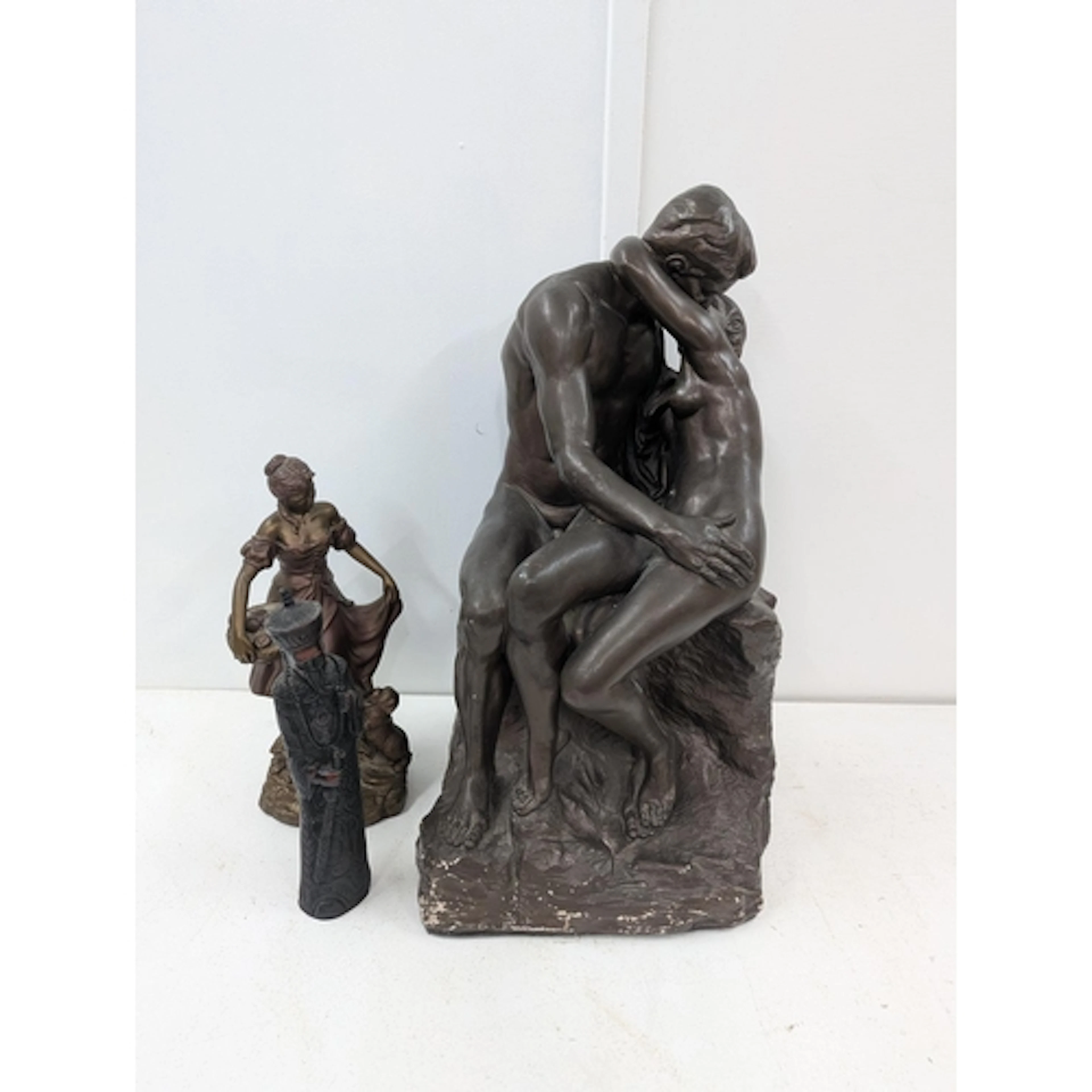 A large bronze coloured plaster sculpture after Auguste Rodi...