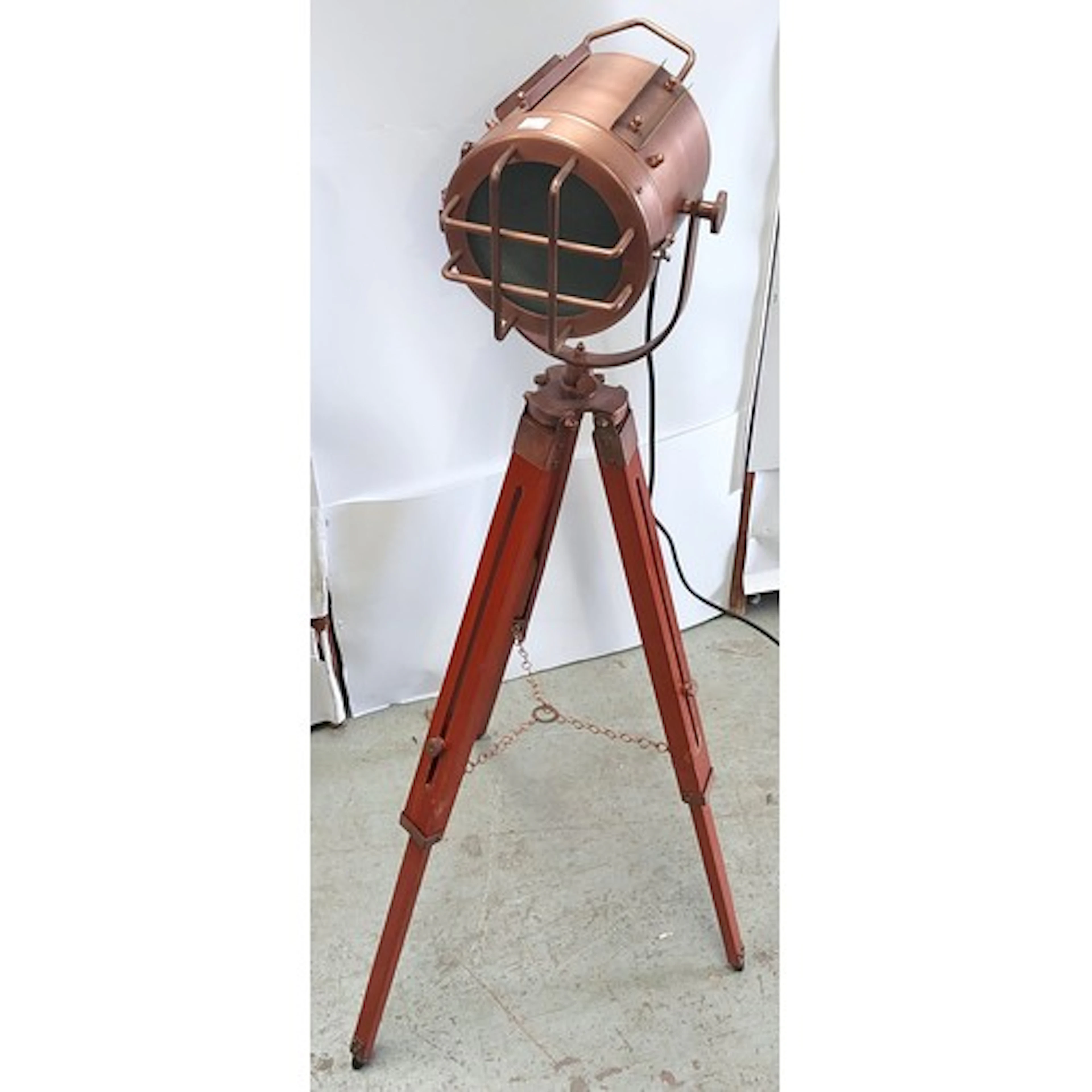 A Copper nautical searchlight floor lamp.