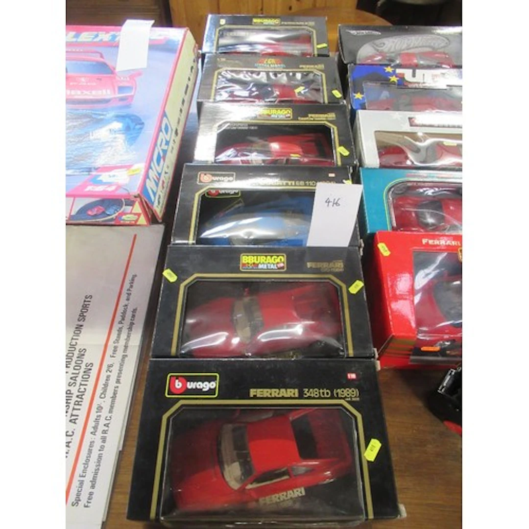 Six Burago die cast models of five Ferraris and a Bugatti