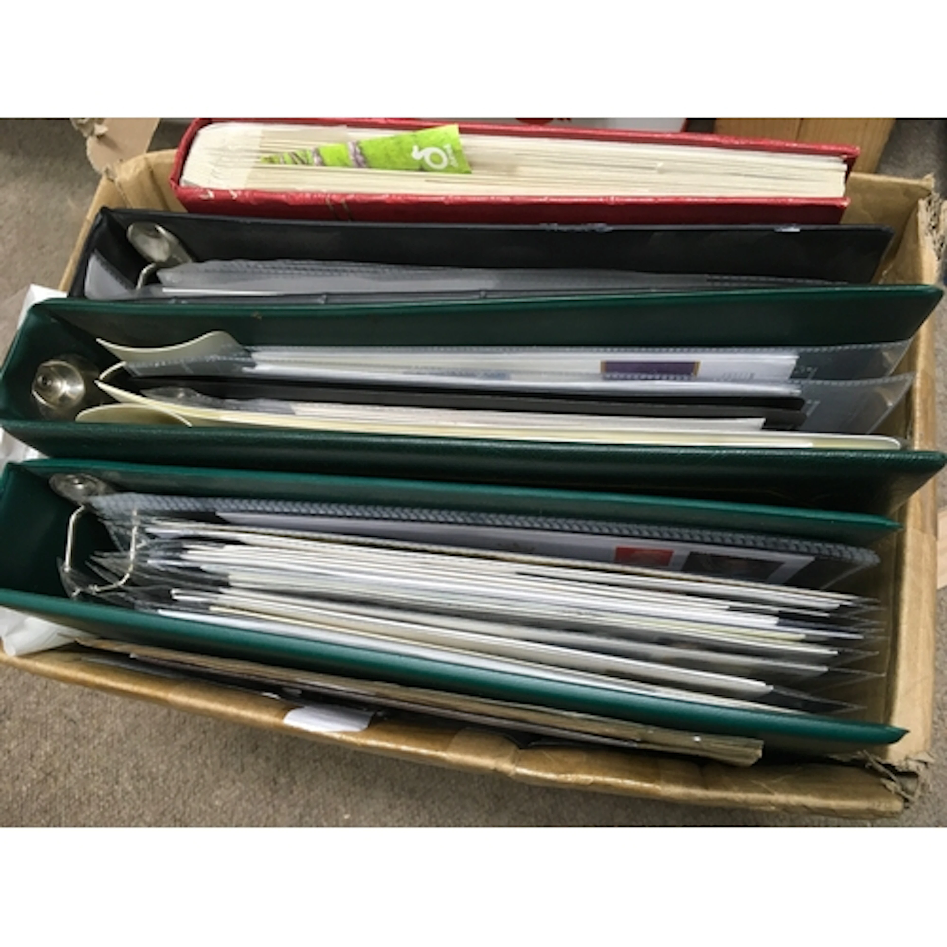 A box containing an album of first day covers, two albums of...