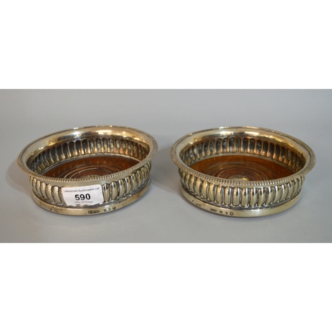 Pair of George III silver coasters, the gadroon rims above t...