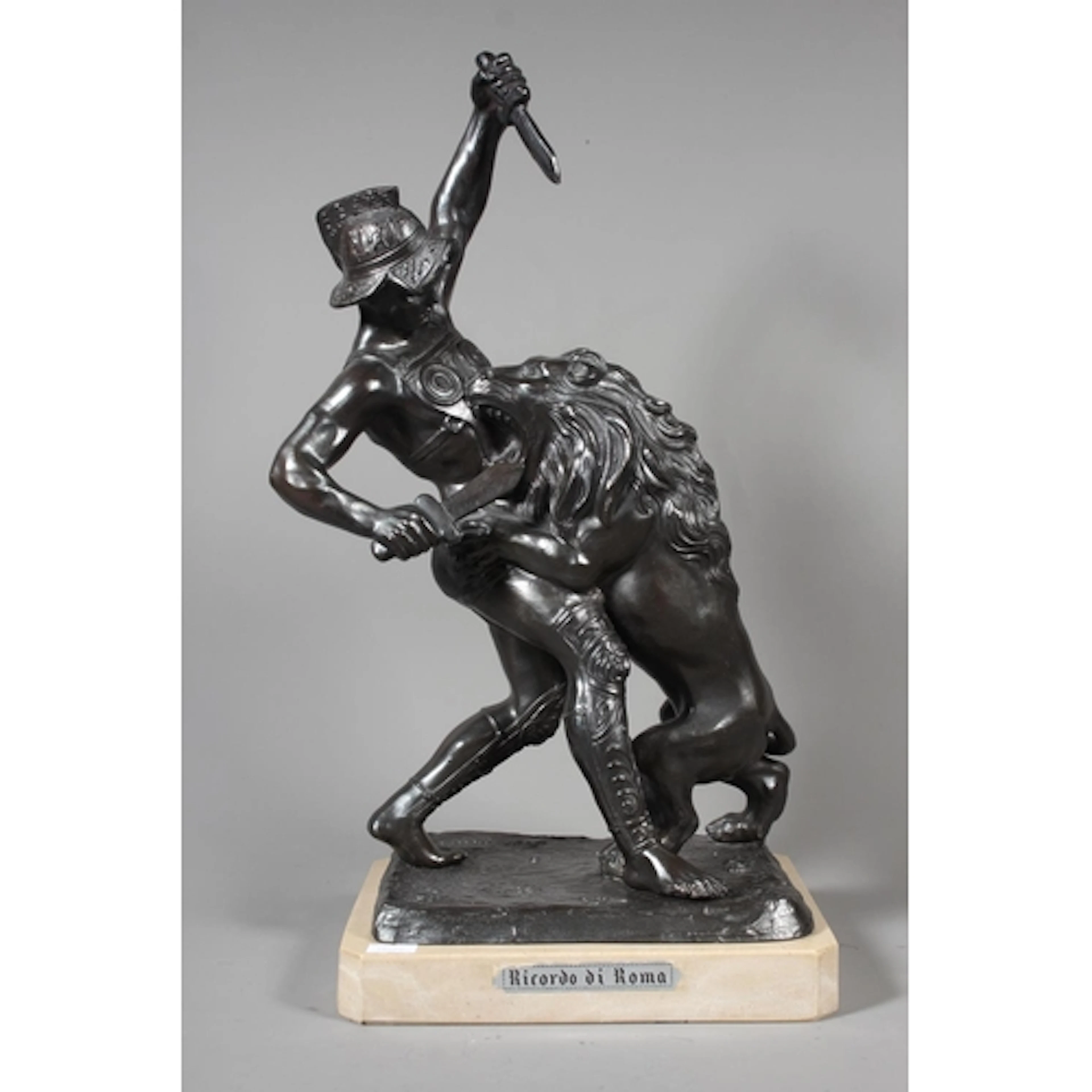 Spelter figure sculpture of a gladiator fighting a lion with...