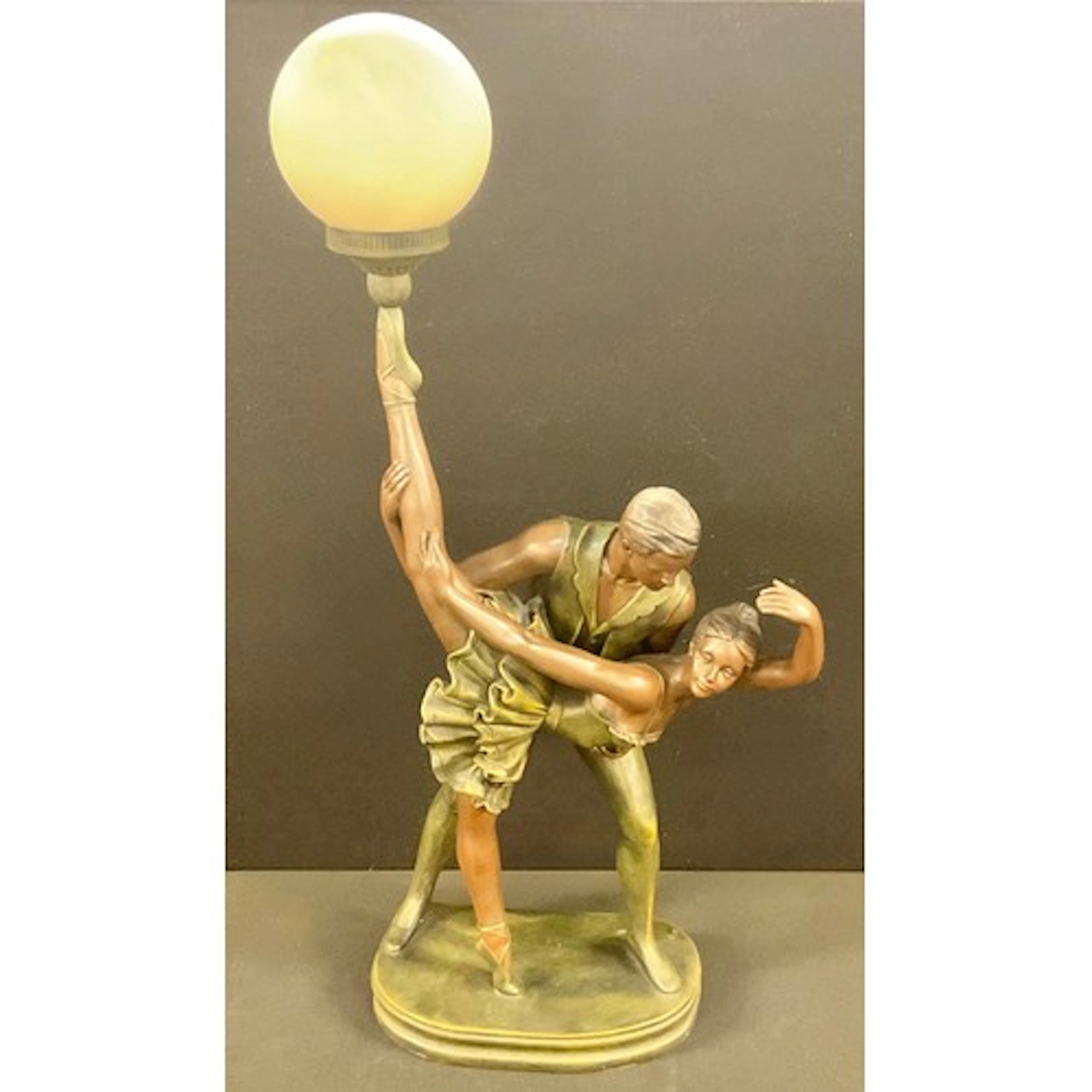 A large decorative moulded resin bronze effect table lamp, a...