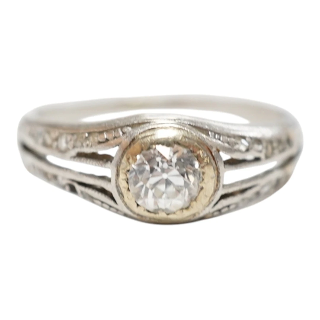 An unmarked white metal and single stone diamond ring, with ...