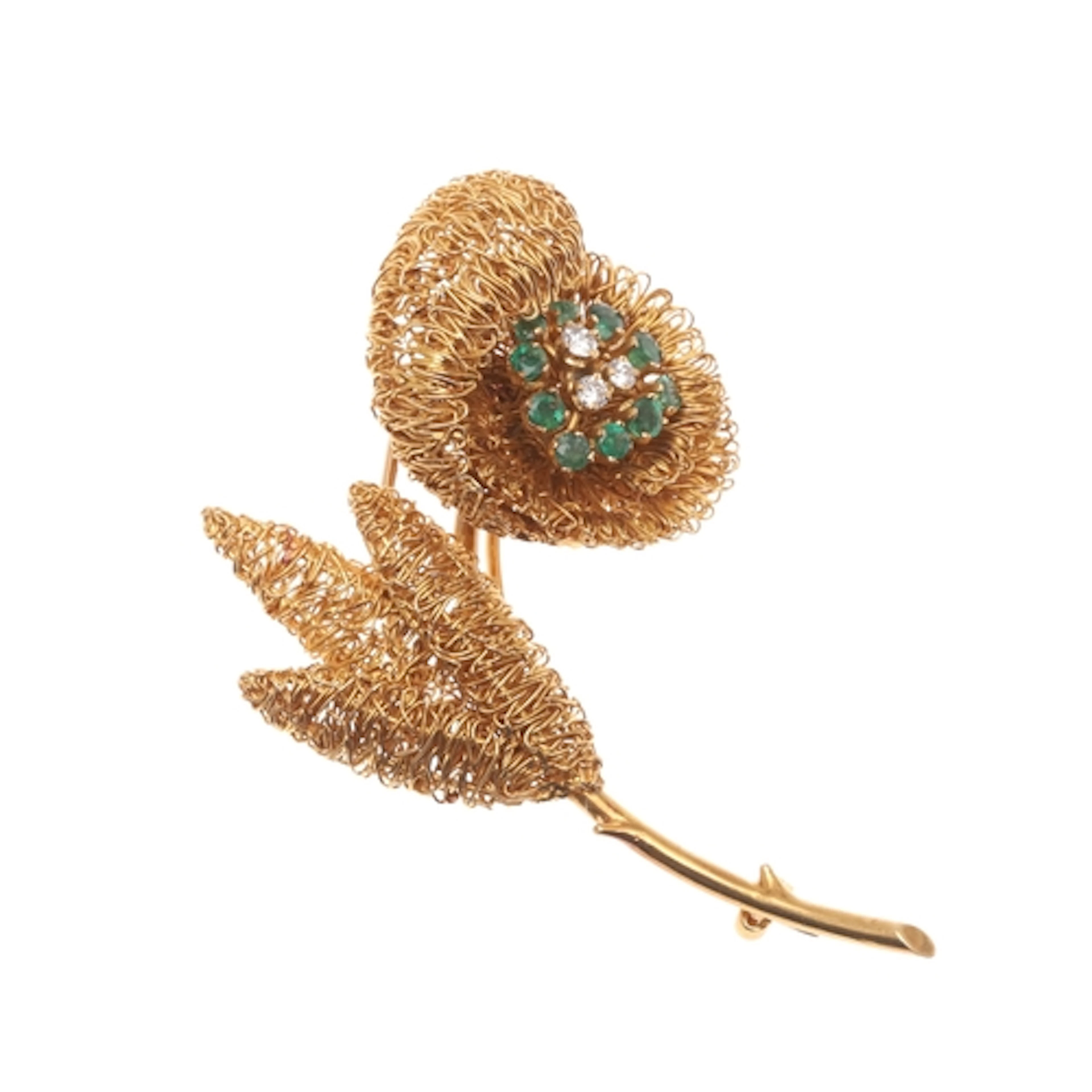 A DIAMOND, EMERALD AND 18CT GOLD FLOWER BROOCH. the flowerhe...