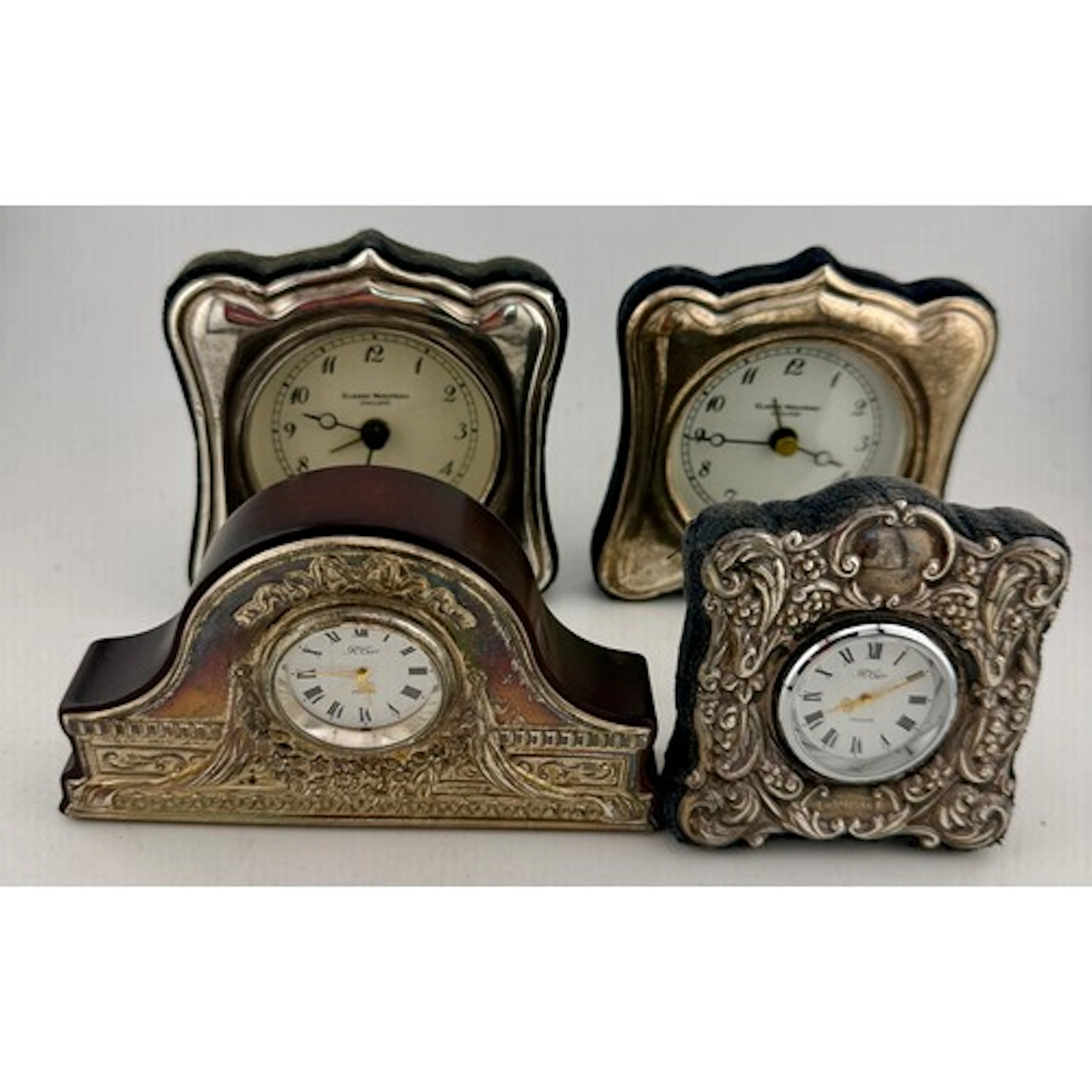 Four 20thC hallmarked silver cased travel clocks.